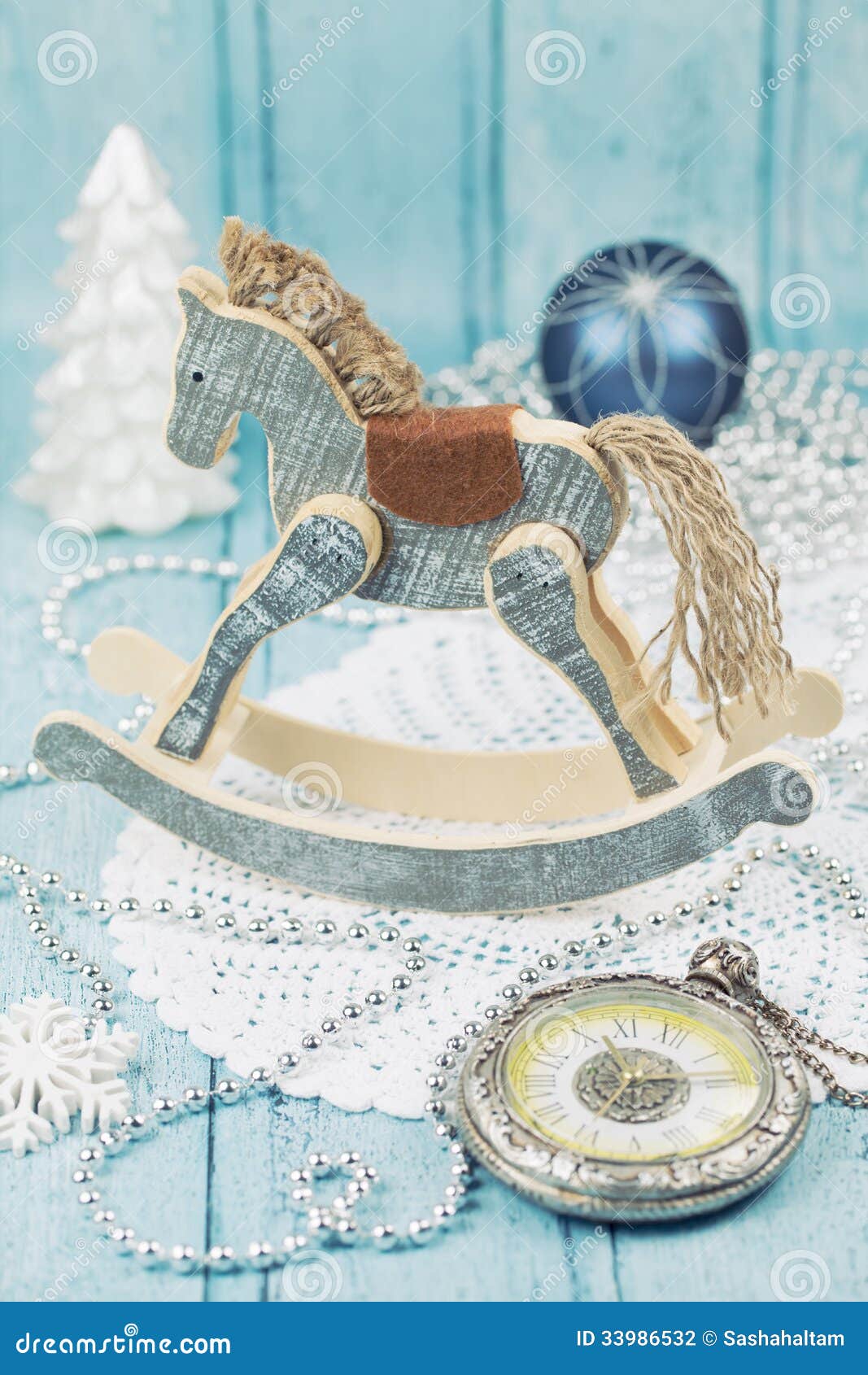 Wooden christmas horse. Wooden horse and clock with Christmas decoration on wooden background in vintage style