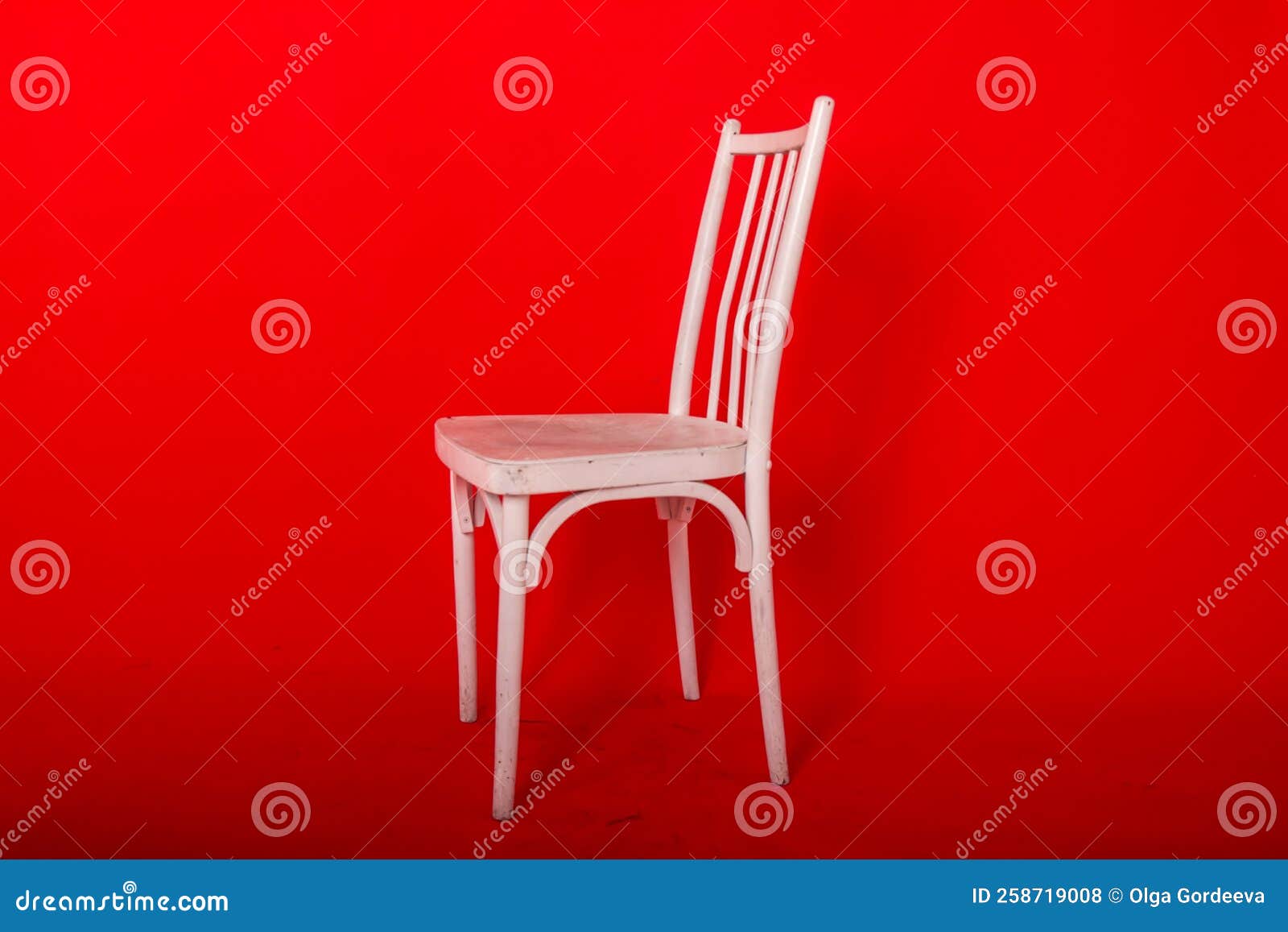 Wooden Comfortable Chair Highlighted on a Red Background Stock Photo