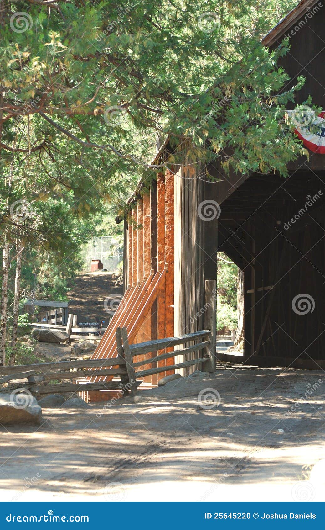 wooden covered bridge over a river in the sierras