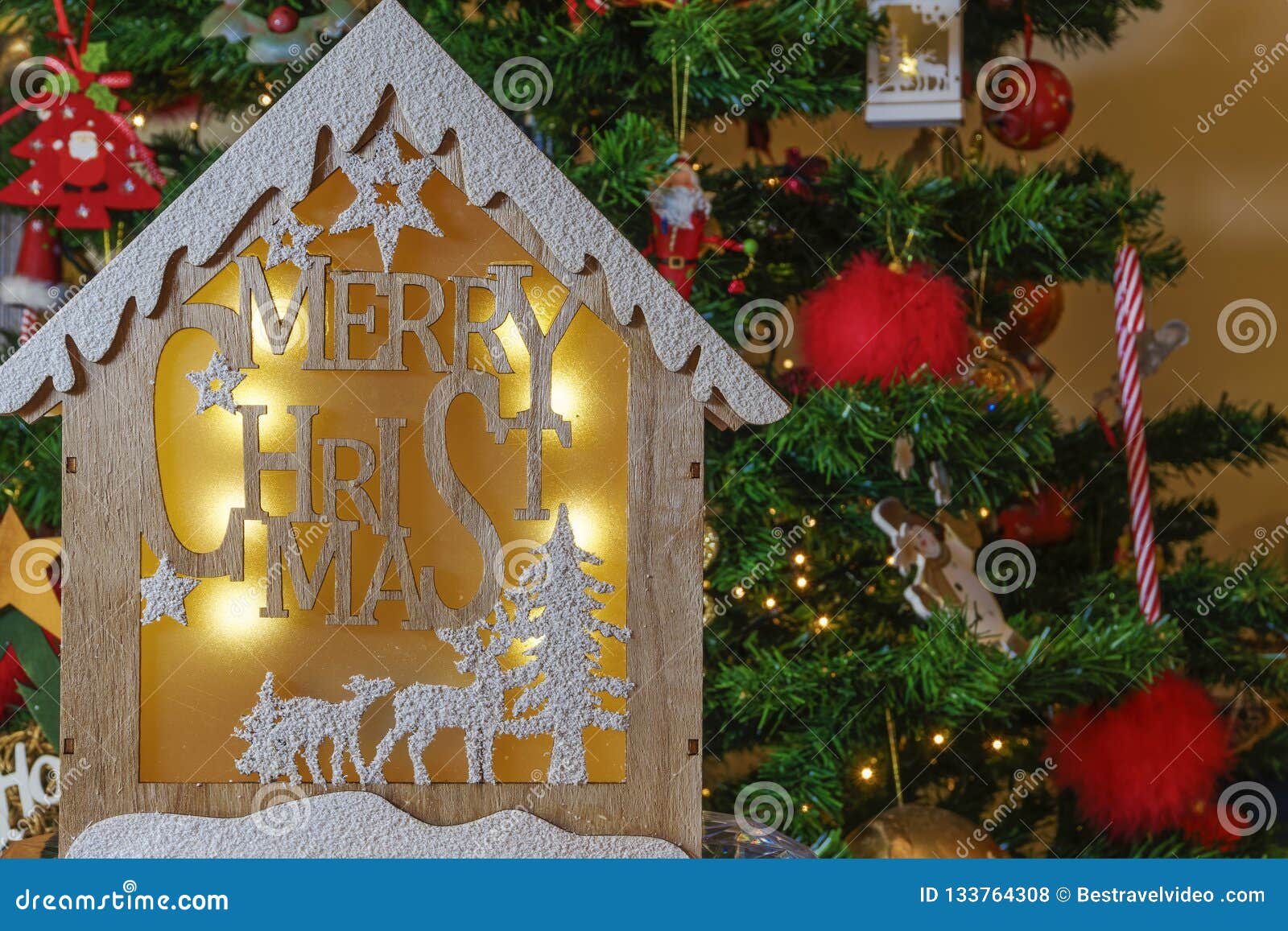 Wooden Crib Design with Merry Christmas Message before Lit Tree. Stock ...