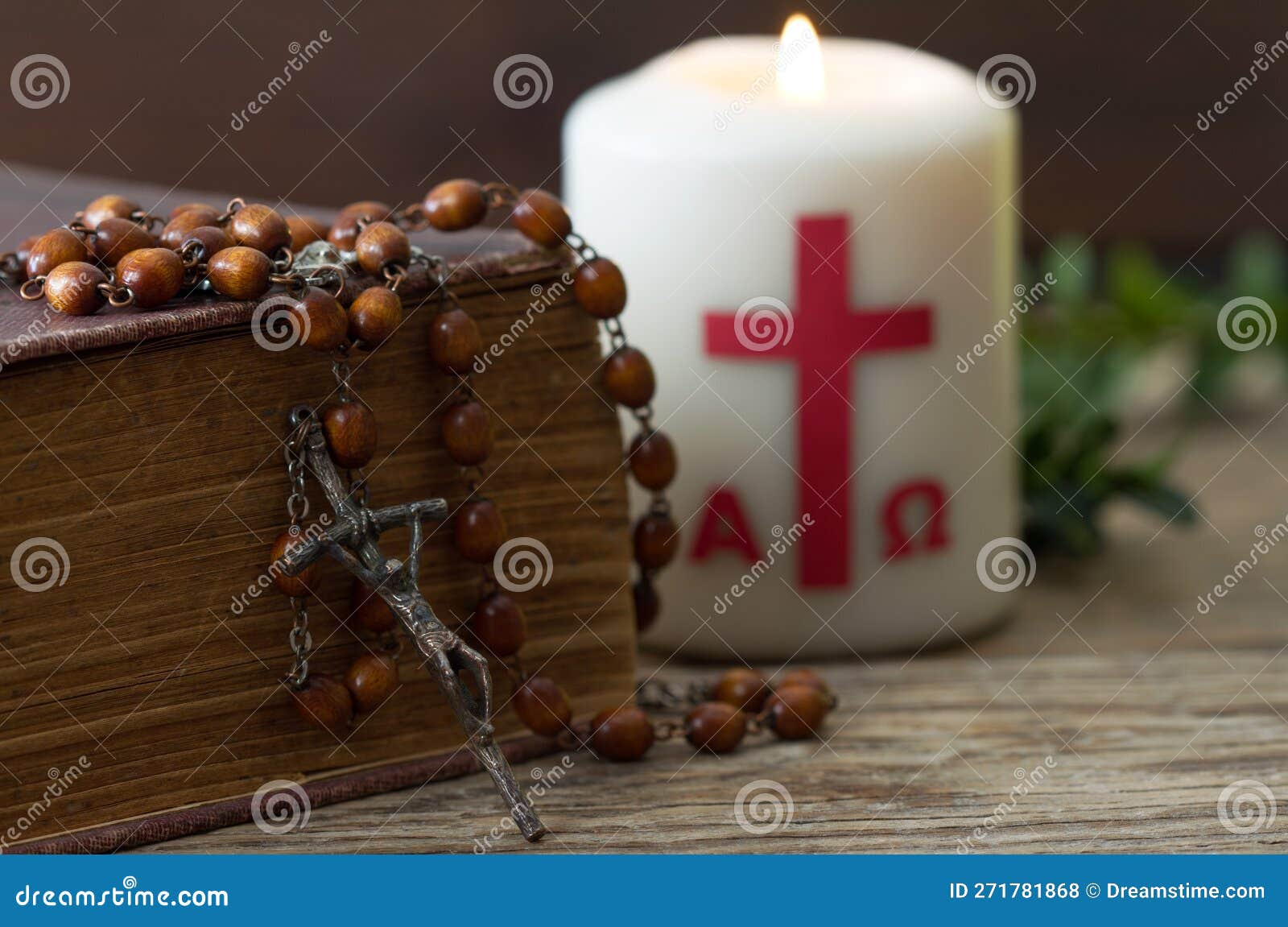 wooden cross with bible, rosary and paschal candle, easter religious concept