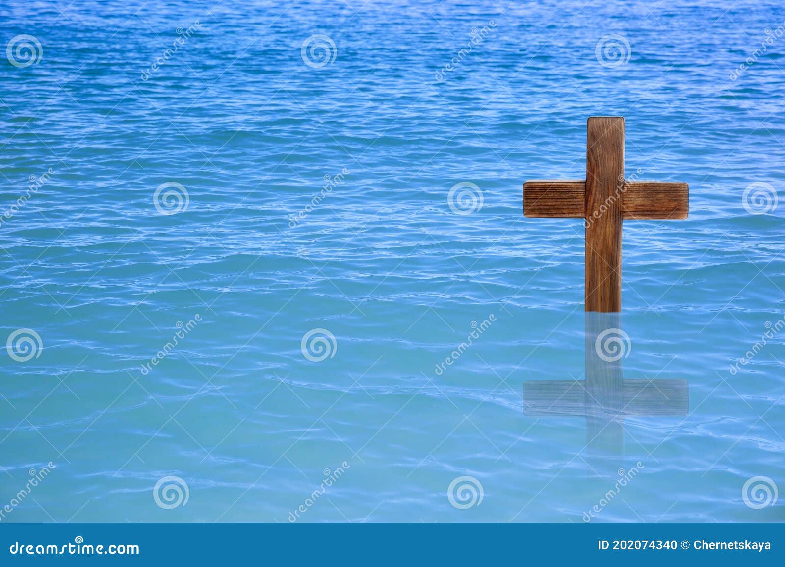 wooden cross in river for religious ritual known as baptism