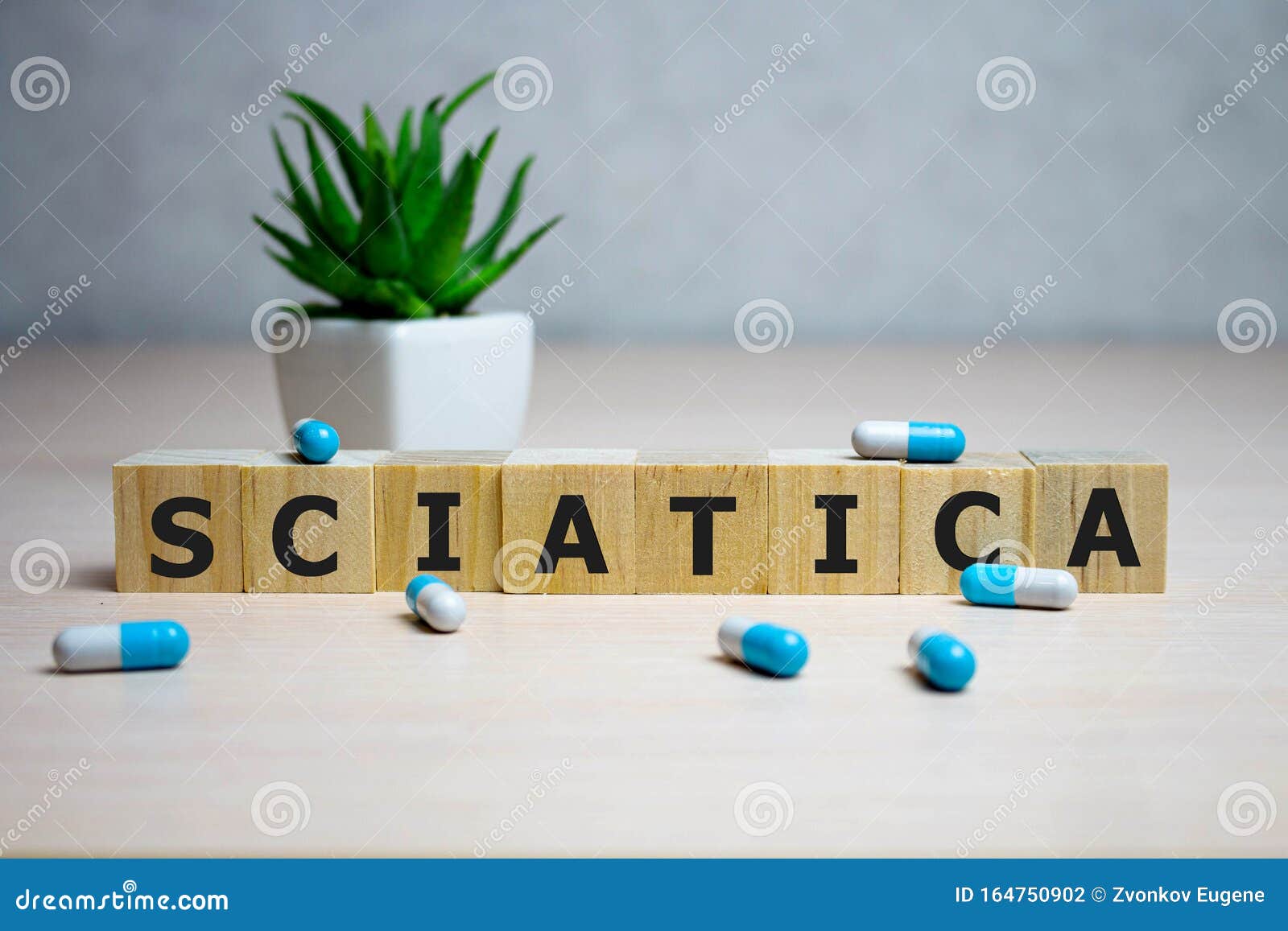 wooden cube with text sciatica. medical concept. background