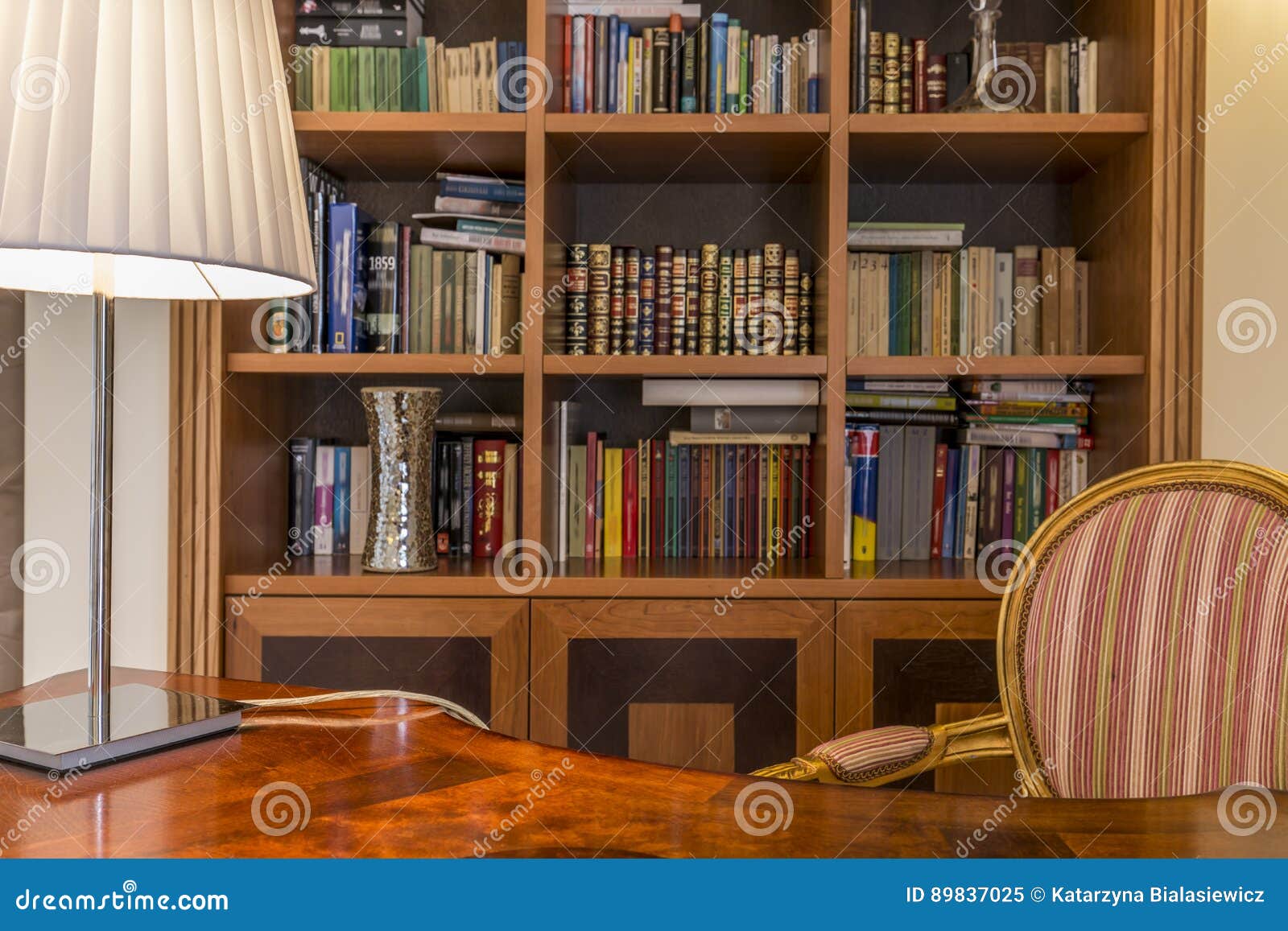 wooden desk and classic bookcase with books
