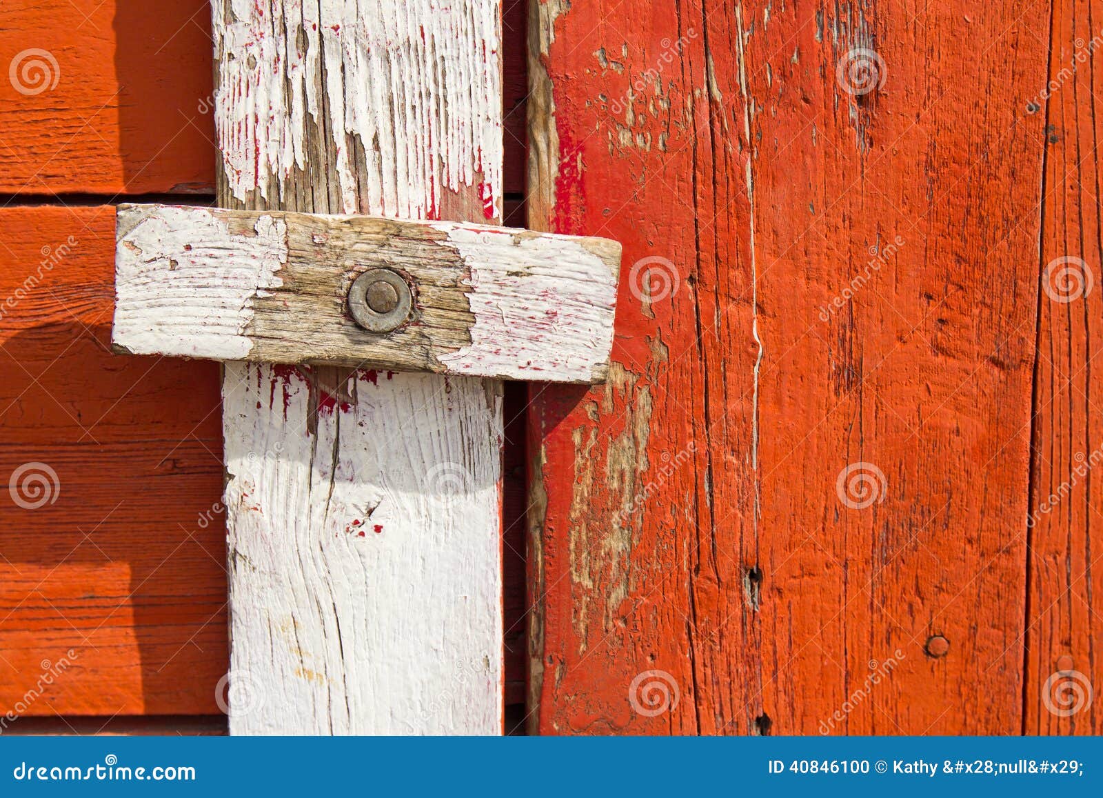 Homemade wood door latch on weathered wood.