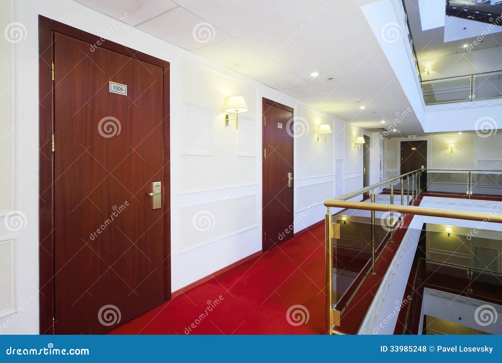 wooden doors, red carpet on floor and handrails of balconies
