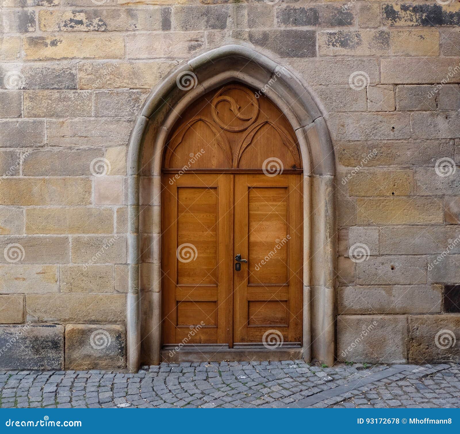 A Wooden Double Door With Pointed Gothic Arch In A Wall Made