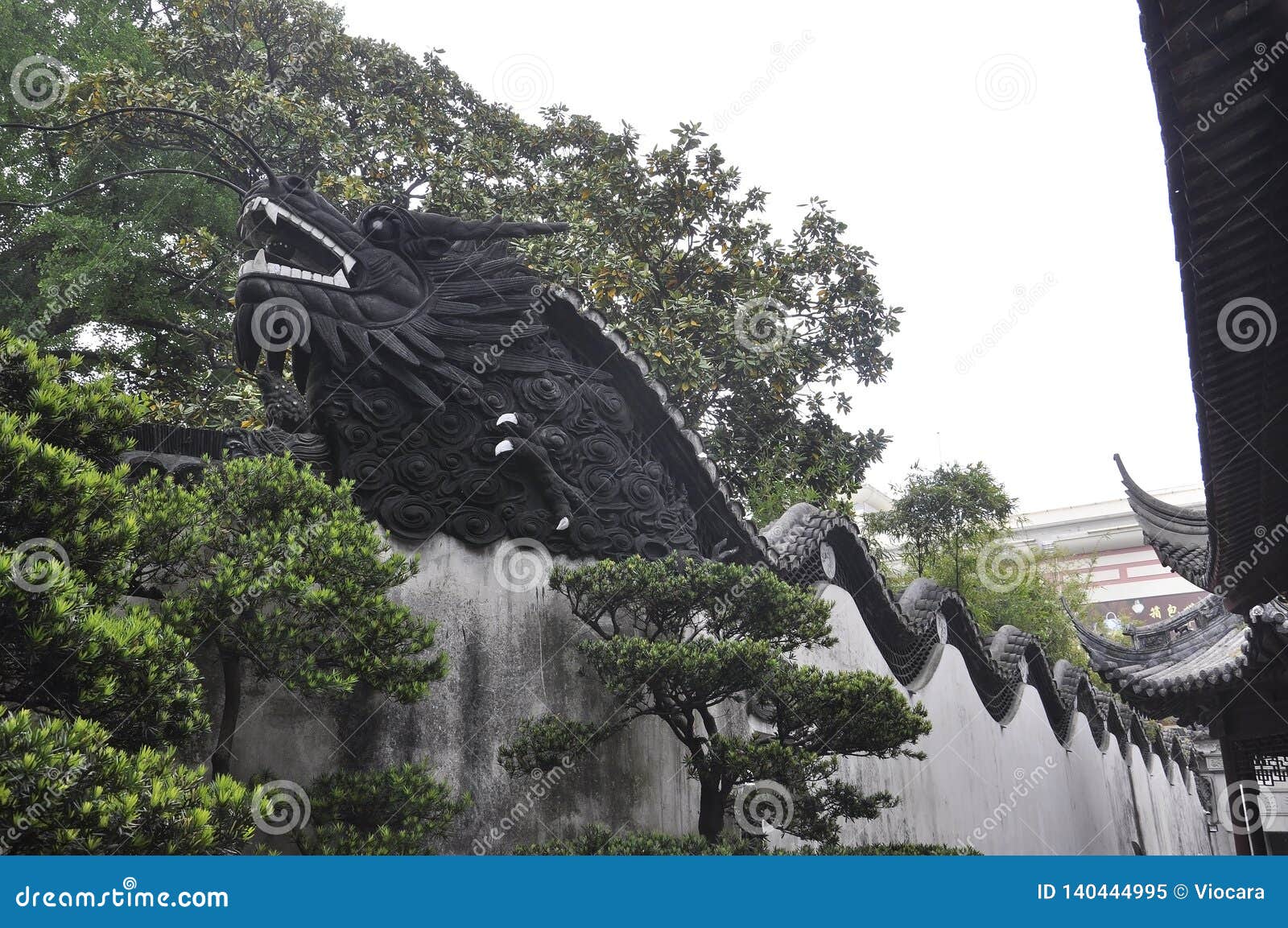 Wooden Dragon Sculpture On The Top Of The Wall In The Famous Yu