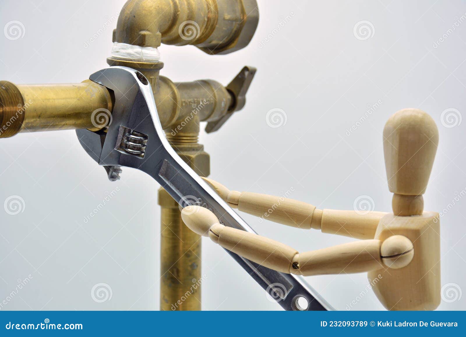 wooden mannequin with an adjustable wrench