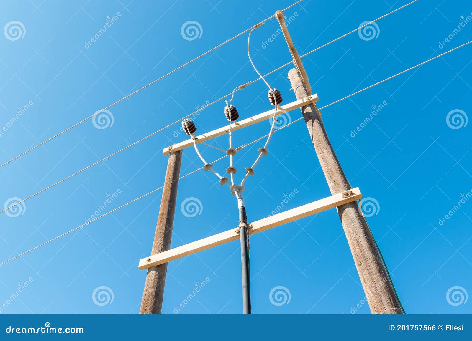 Wooden Electrical Pole with High Voltage Electrical Wires Against the