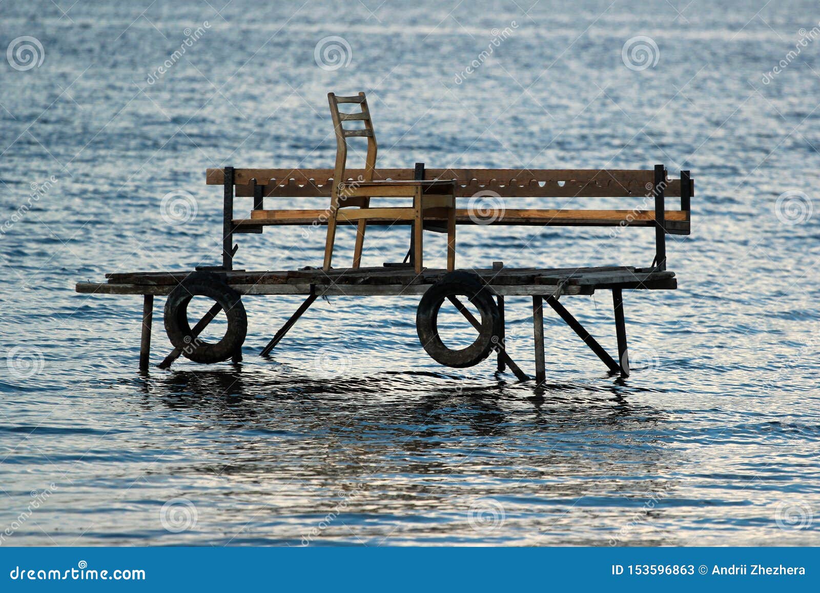 Wooden Fishing Platform in Water, with Tire Fenders and Chair