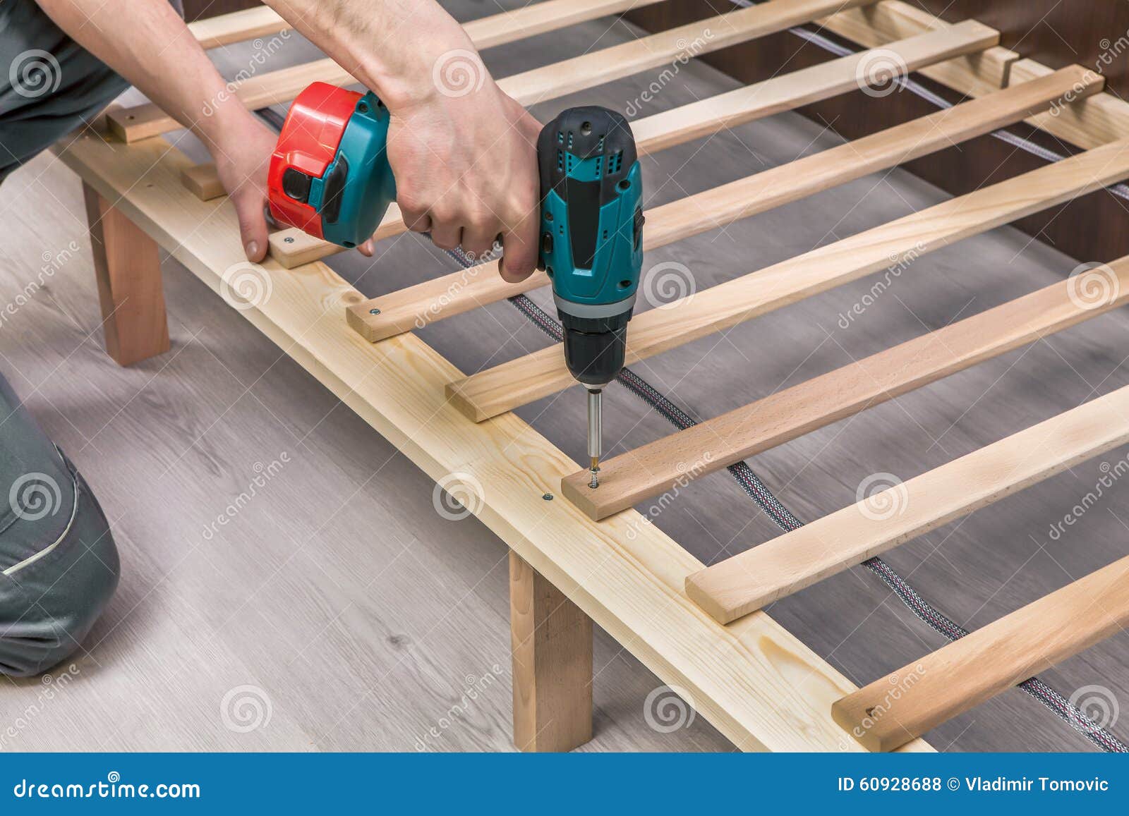 wooden furniture assembling- woodworker screwing screws