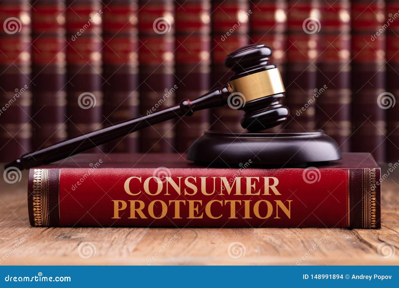 wooden gavel and soundboard on consumer protection law book