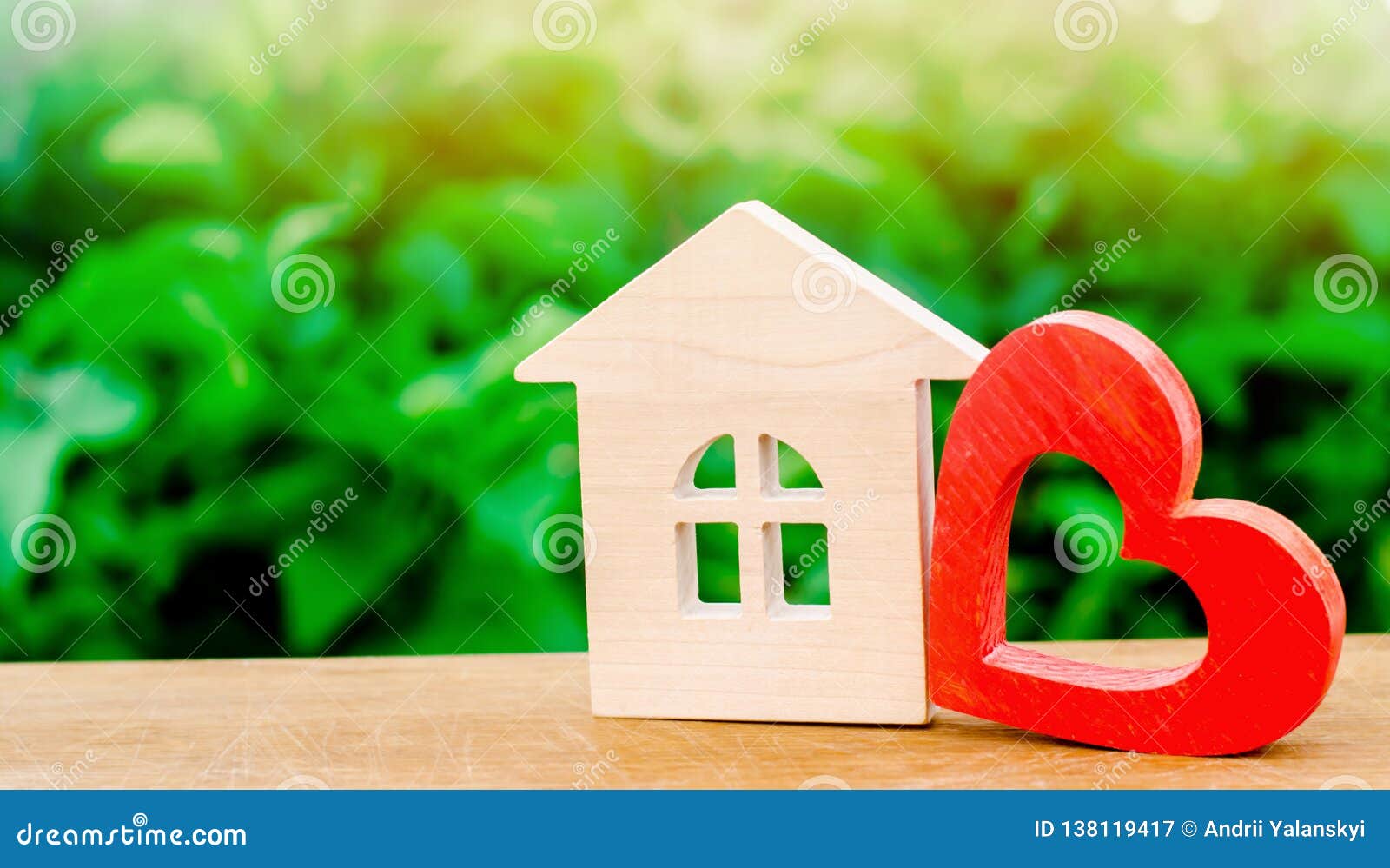 wooden house and red heart. concept of sweet home. property insurance. family comfort. affordable housing for young families.