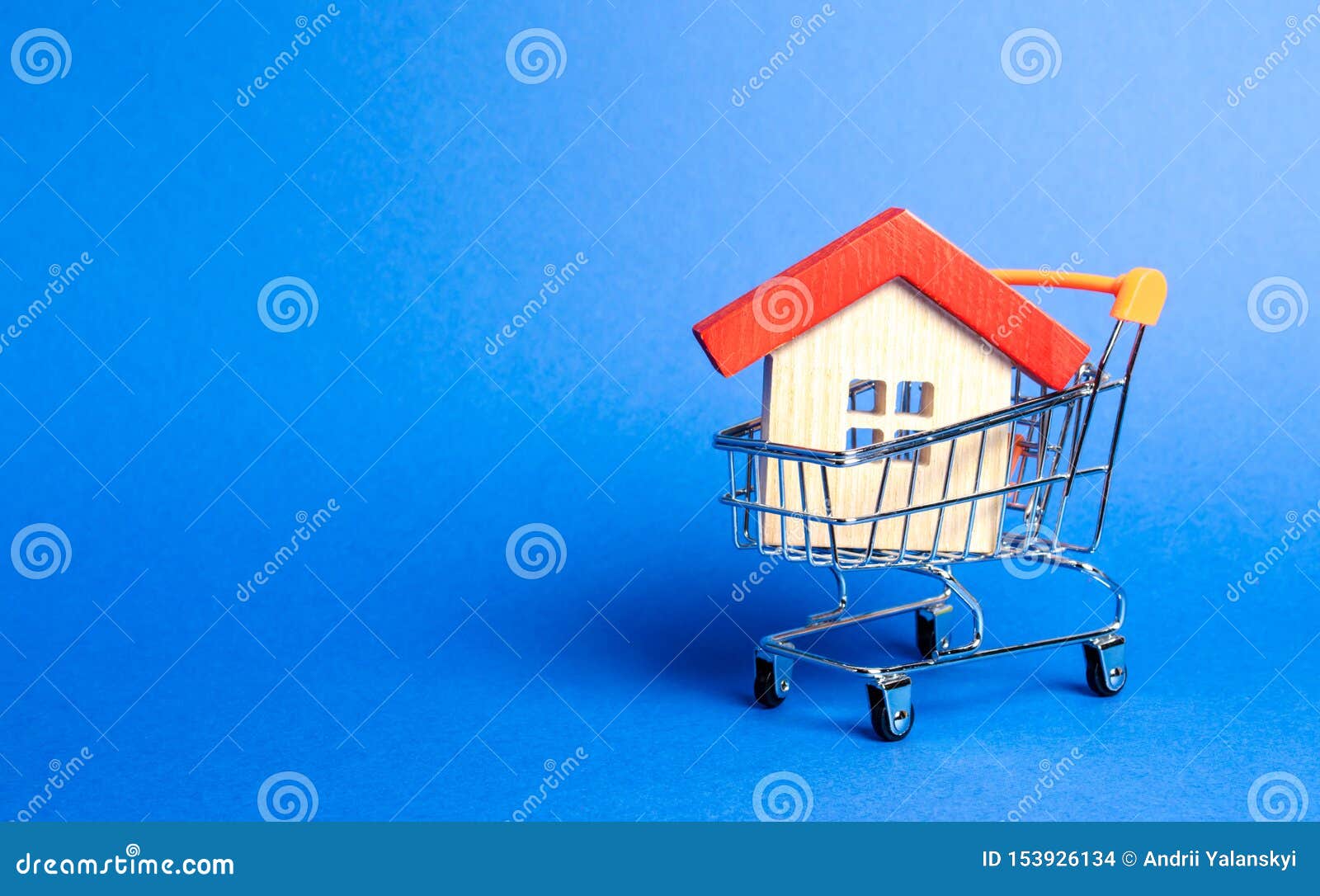 wooden house in a supermarket trading cart. the concept of buying a house or apartment. affordable housing. profitable and cheap