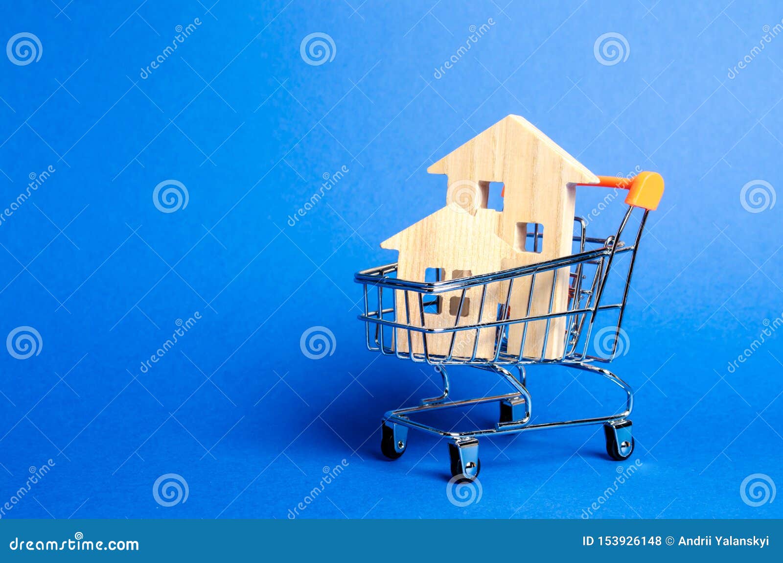 wooden houses in a trading cart. the concept of buying a house or apartment. affordable housing. profitable and cheap loans