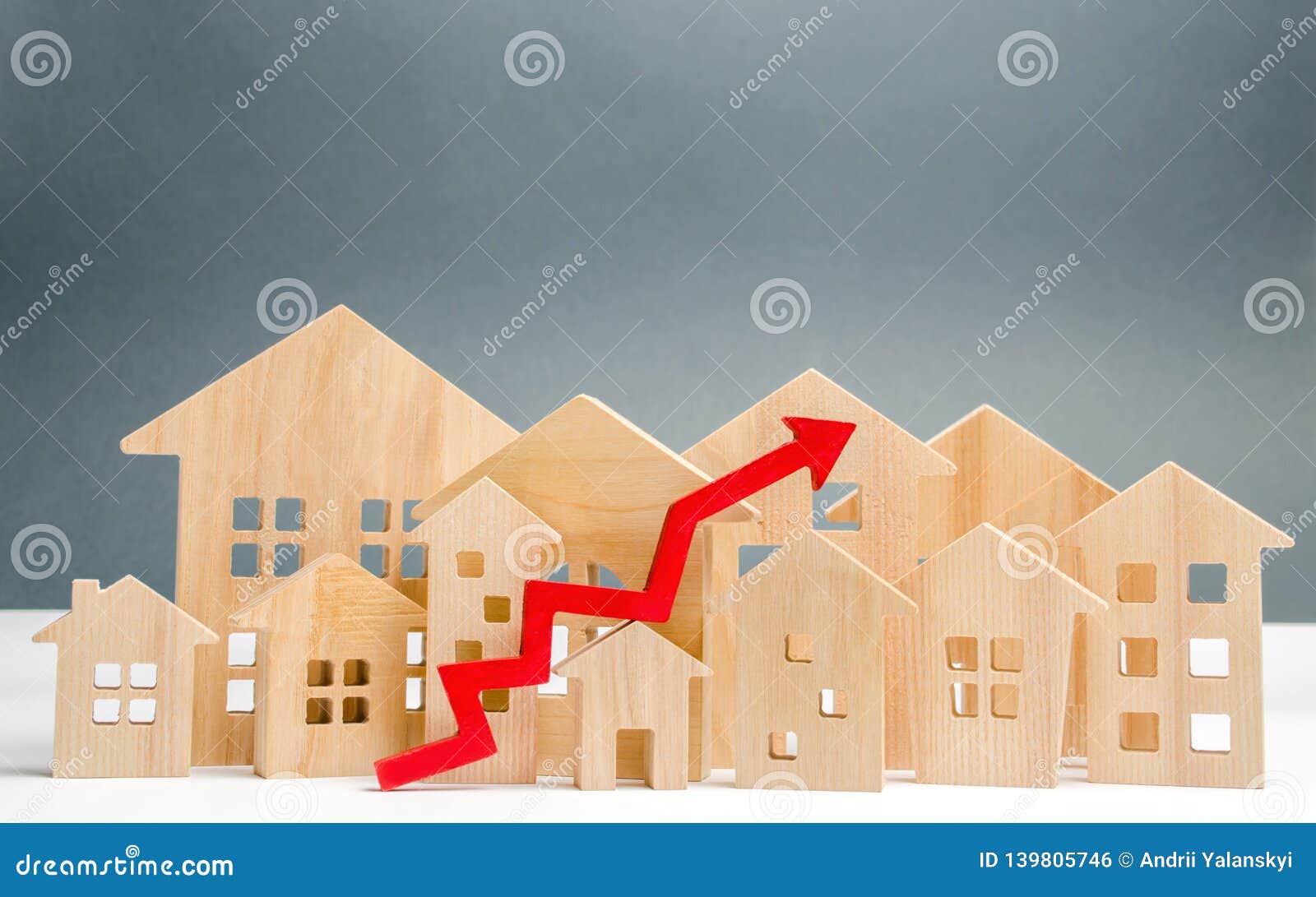 wooden houses and up arrow. the concept of real estate market growth. the increased in housing prices. rise price for utilities /