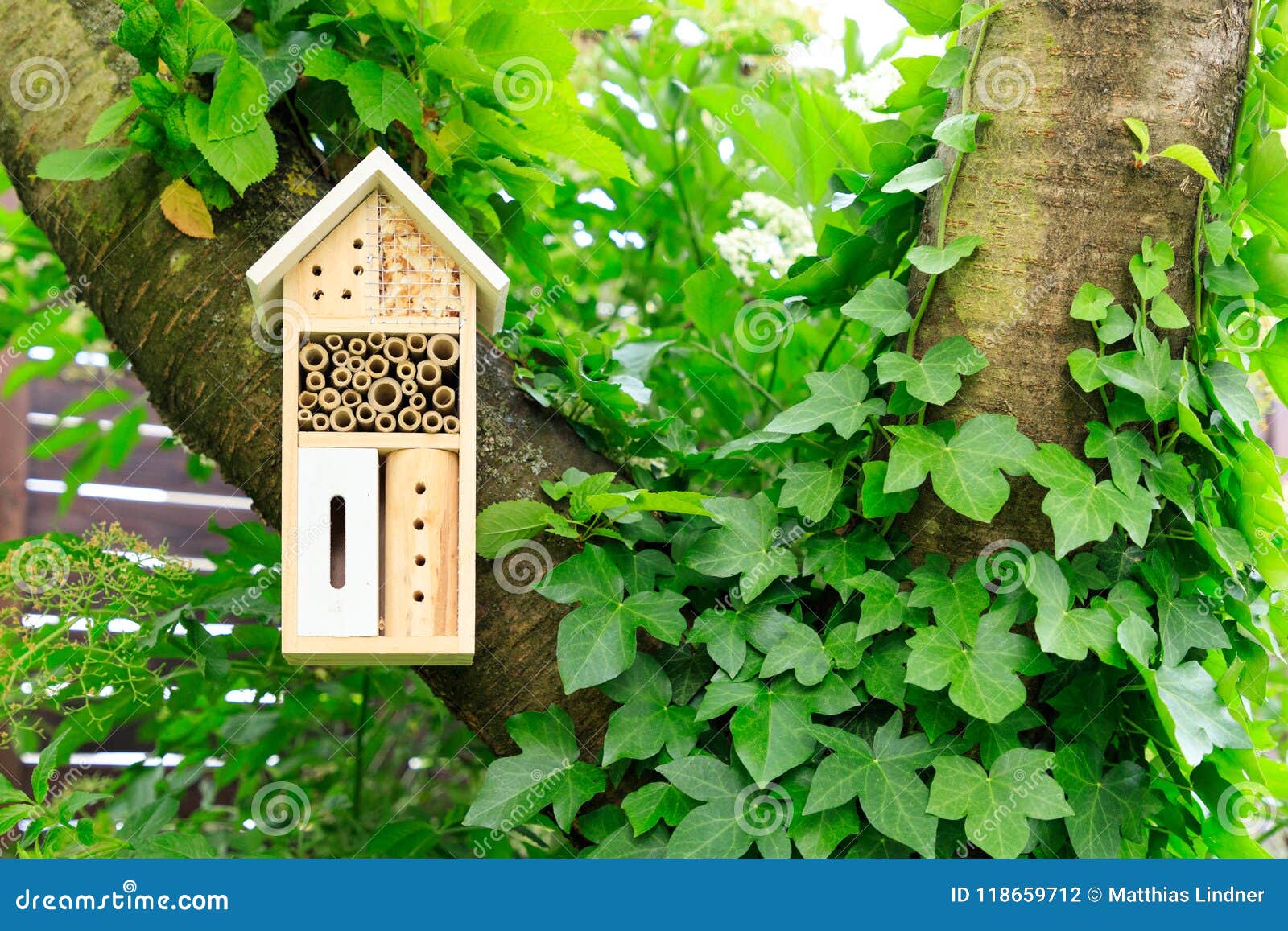 a wooden insect hotel in the tree