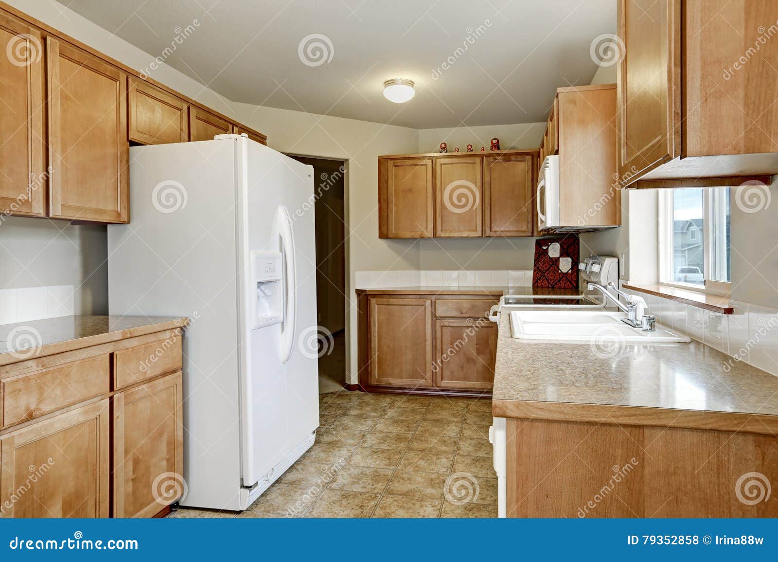 Wooden Kitchen Storage Combination and White Fridge Stock Photo Image