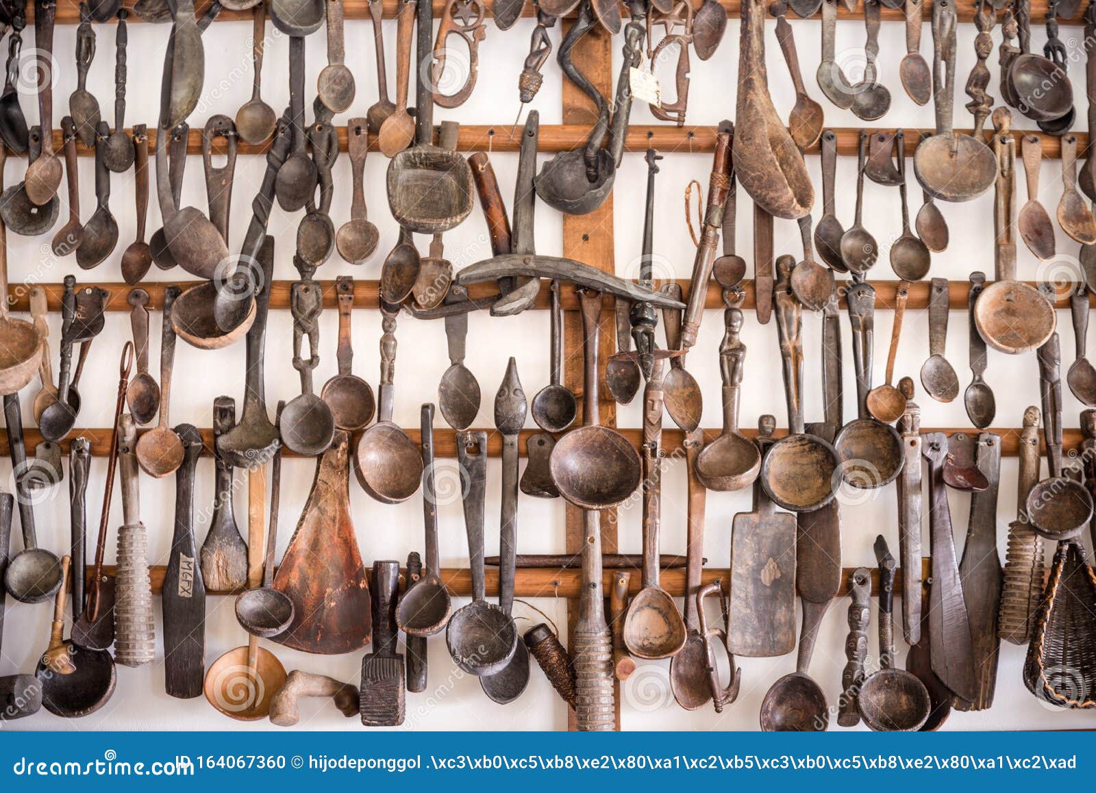 Wooden Kitchen Utensils Hanged As Decorative Display on Wall Stock