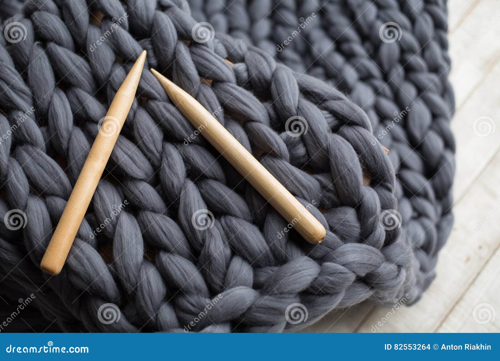 Wooden Knitting Needles on Background of Grey Merino Wool Stock