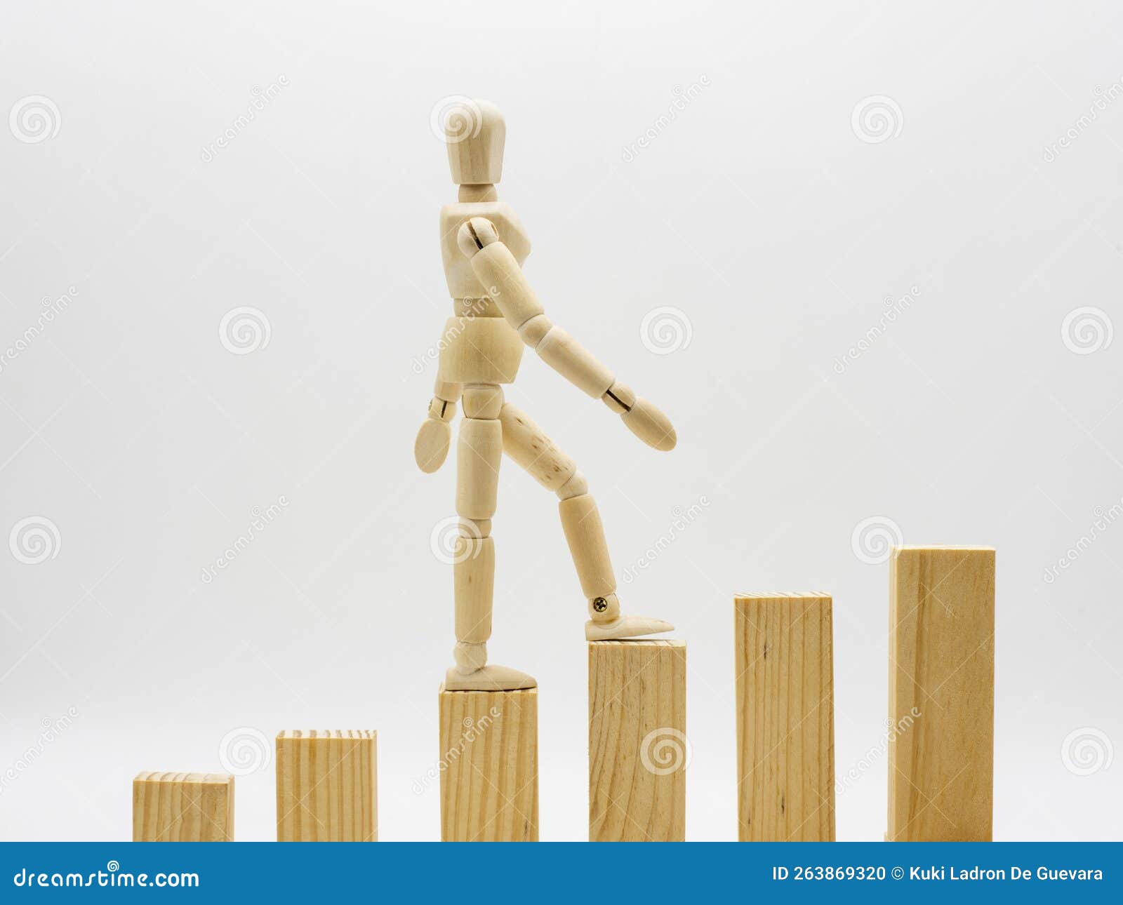 wooden mannequin climbing a ladder,  on white