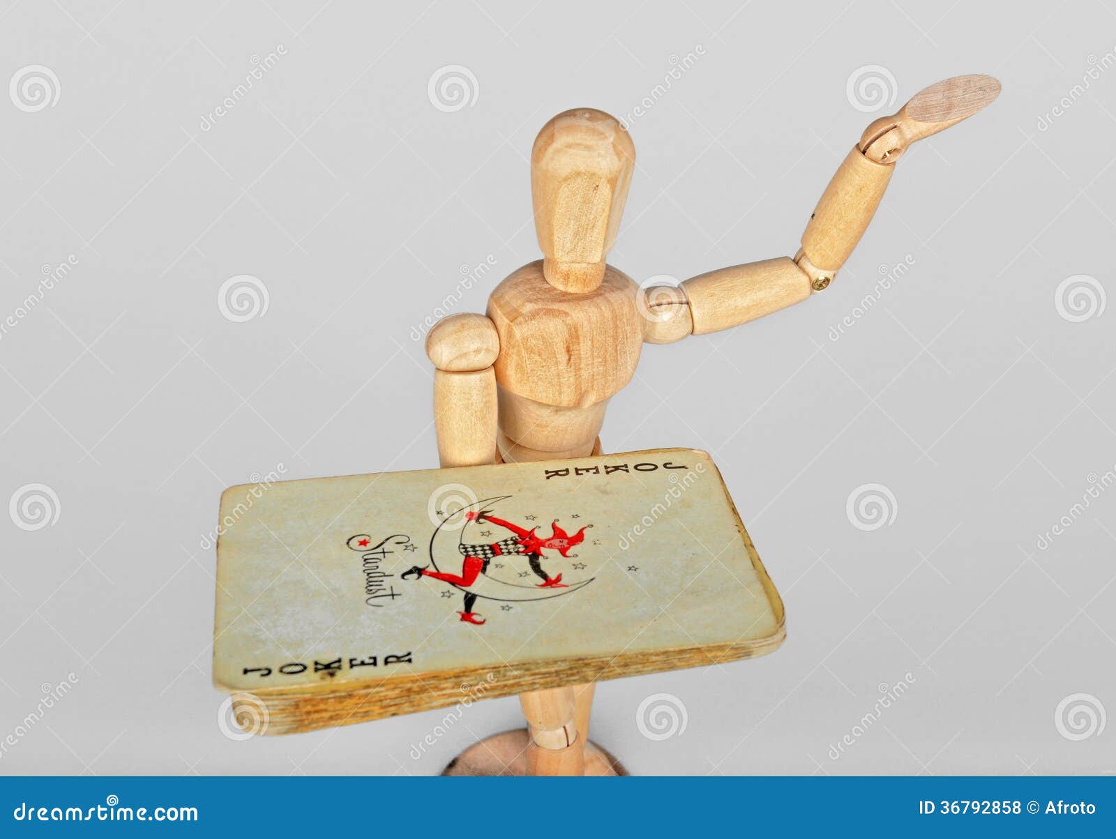 Wooden mannequin with playing cards. Old vintage poker cards in the hand of the wooden mannequin