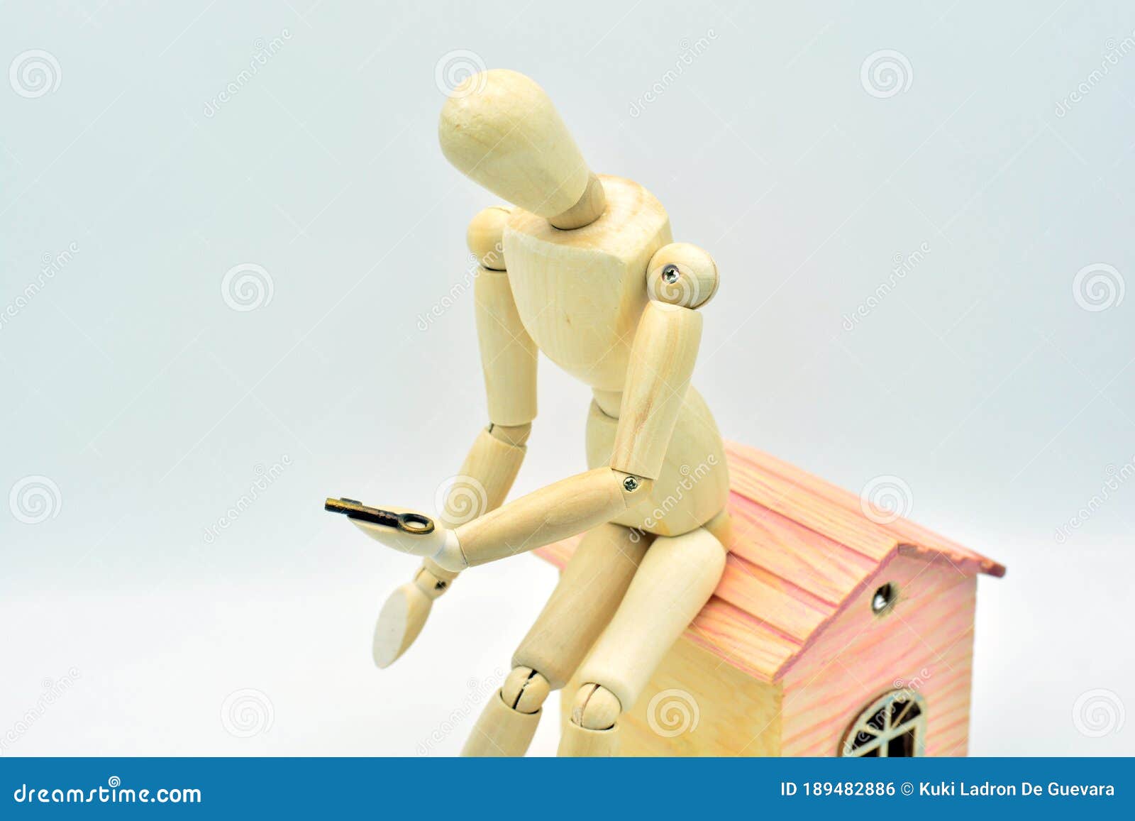 wooden mannequin sitting in a house