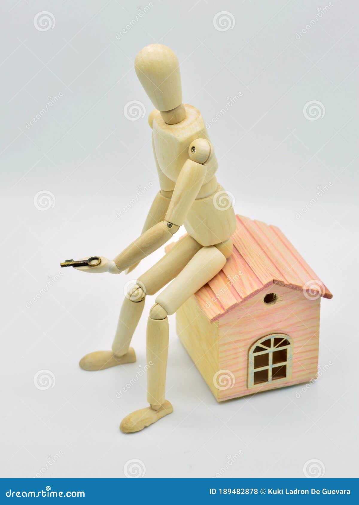 wooden mannequin sitting in a house