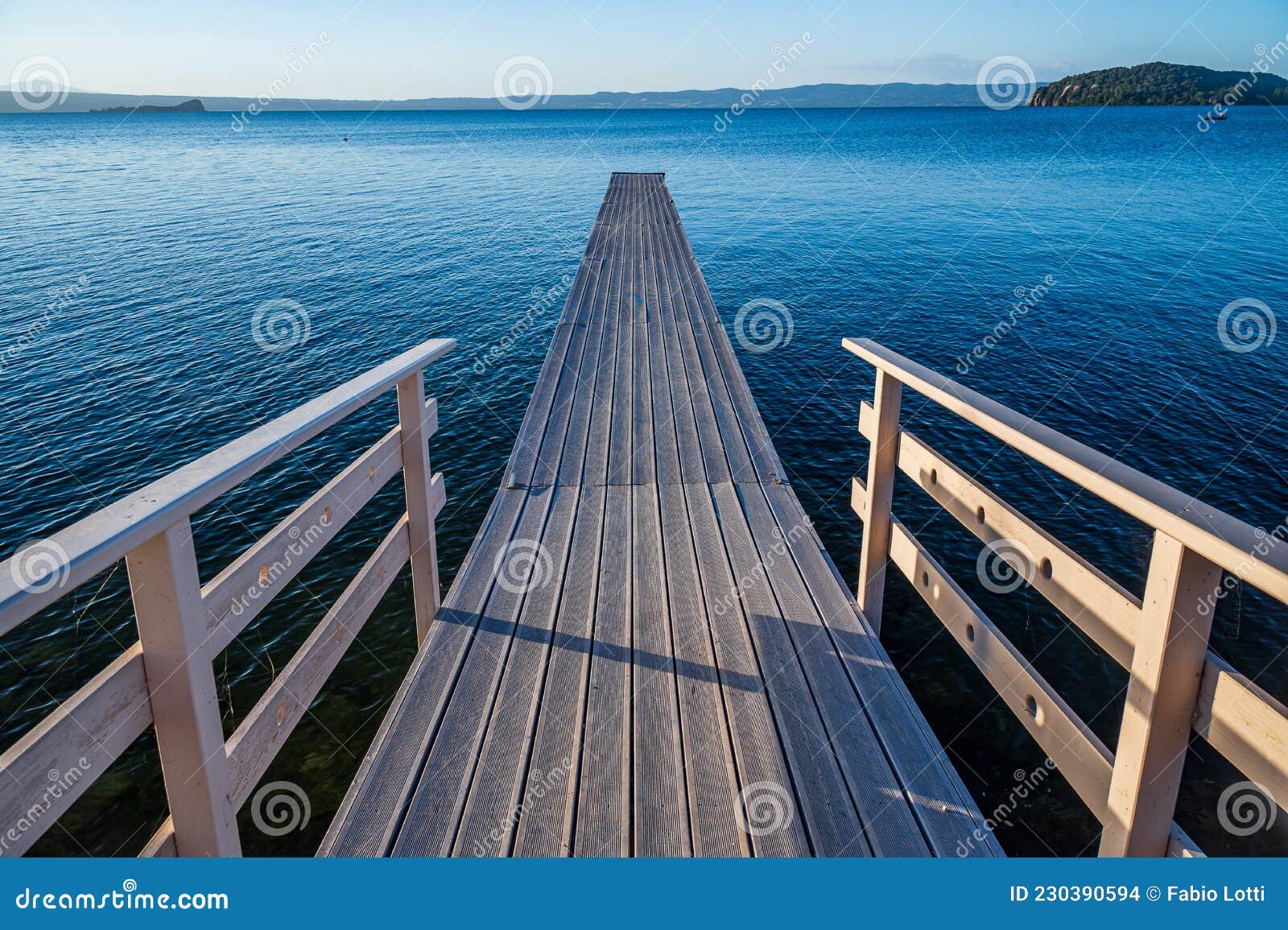 wooden pier on the bolsena lake near marta
