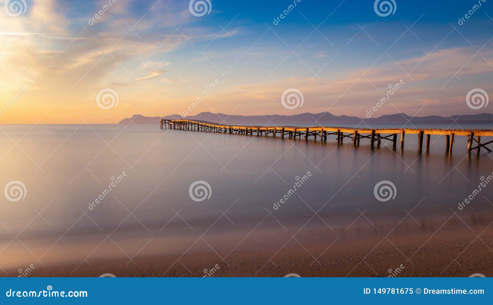 wooden pier / jetty, playa de muro, alcudia, sunrise, mountains, secluded beach, golden sunlight, reflection, beautiful sky,