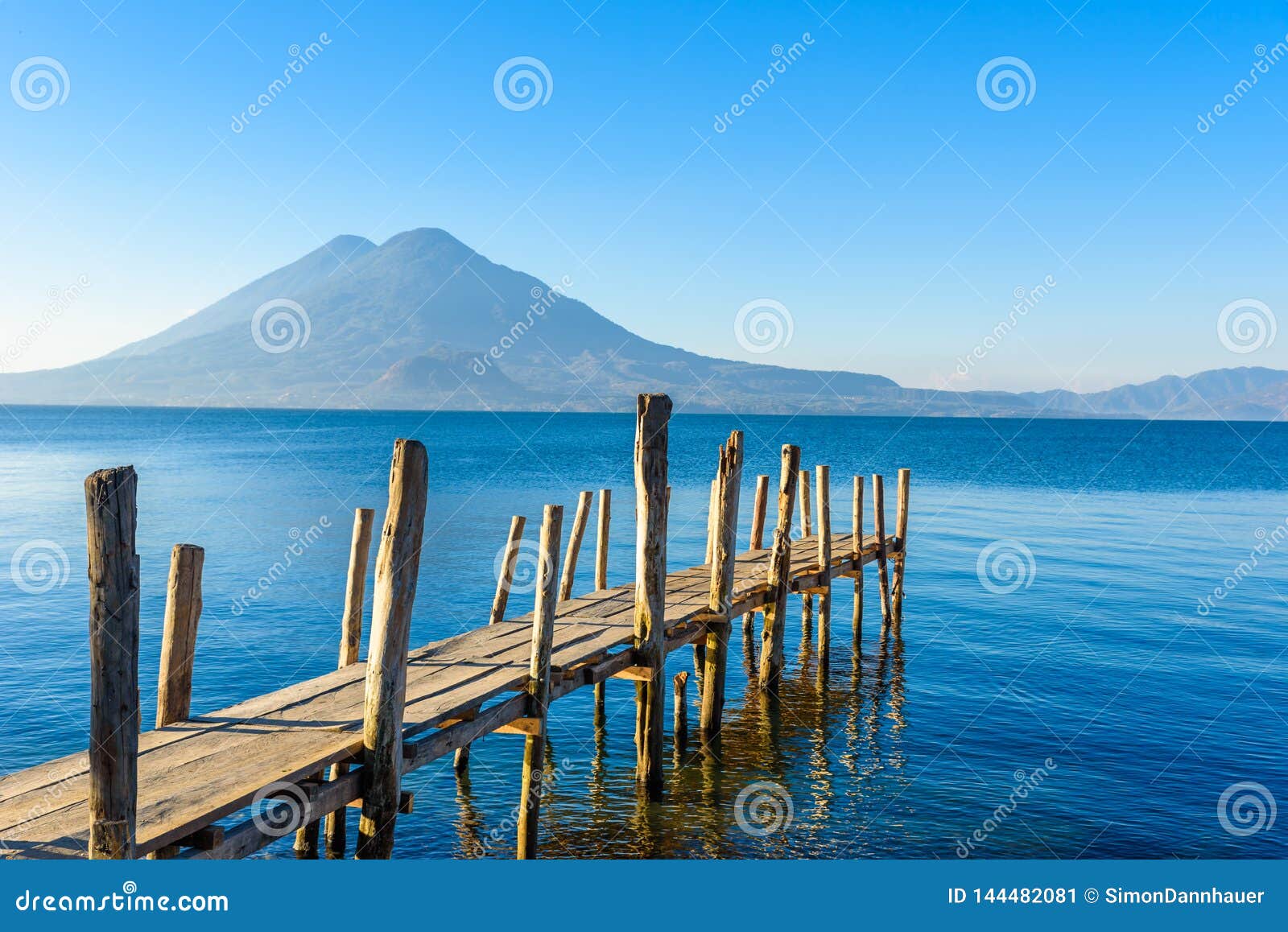 wooden pier at lake atitlan on the beach in panajachel, guatemala. with beautiful landscape scenery of volcanoes toliman, atitlan