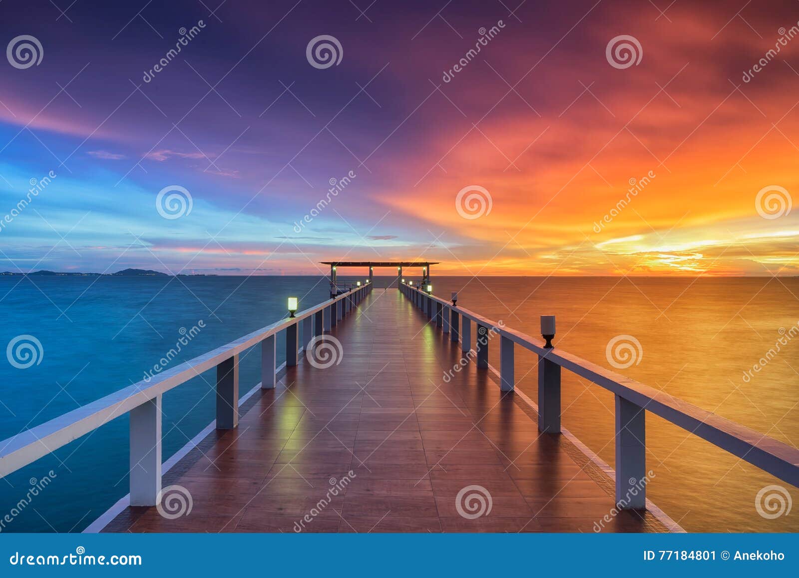 wooden pier between sunset