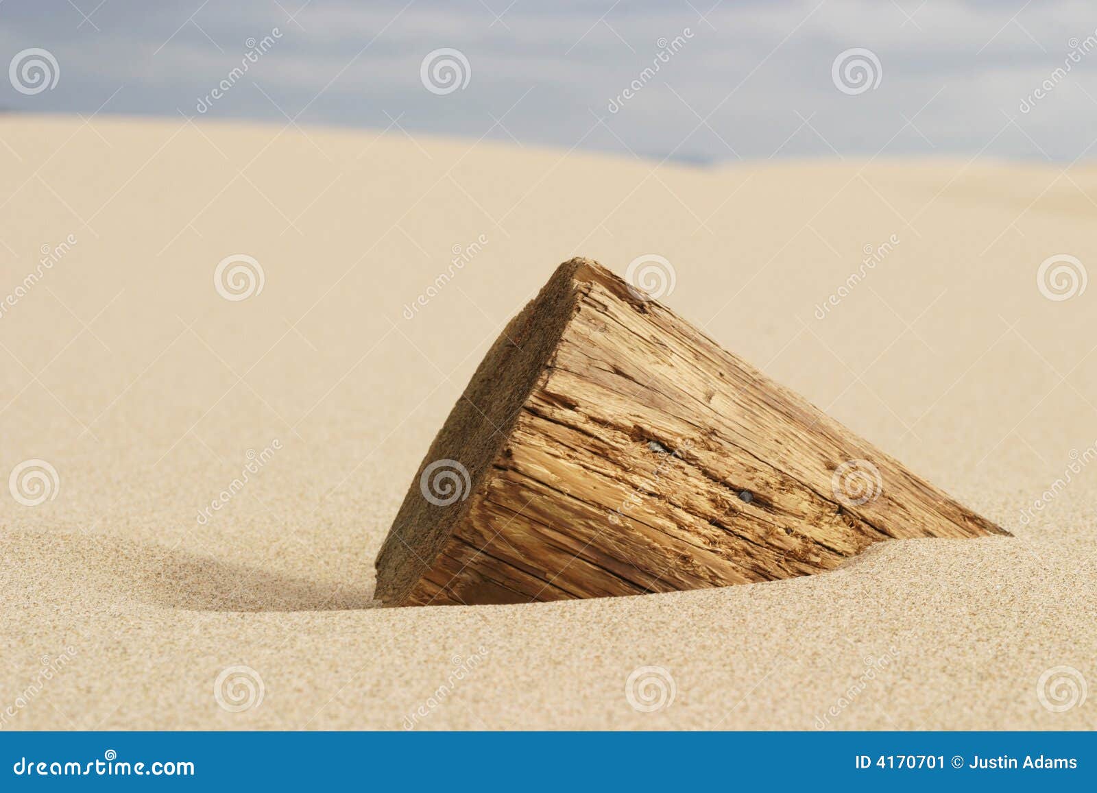 Wooden Pole Buried in Sand stock image. Image of terrain 4170701