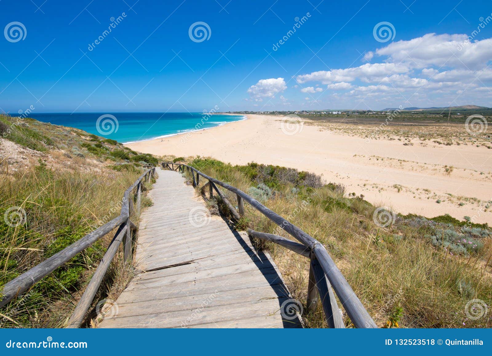 wooden ramp with railing down to the zahora beach