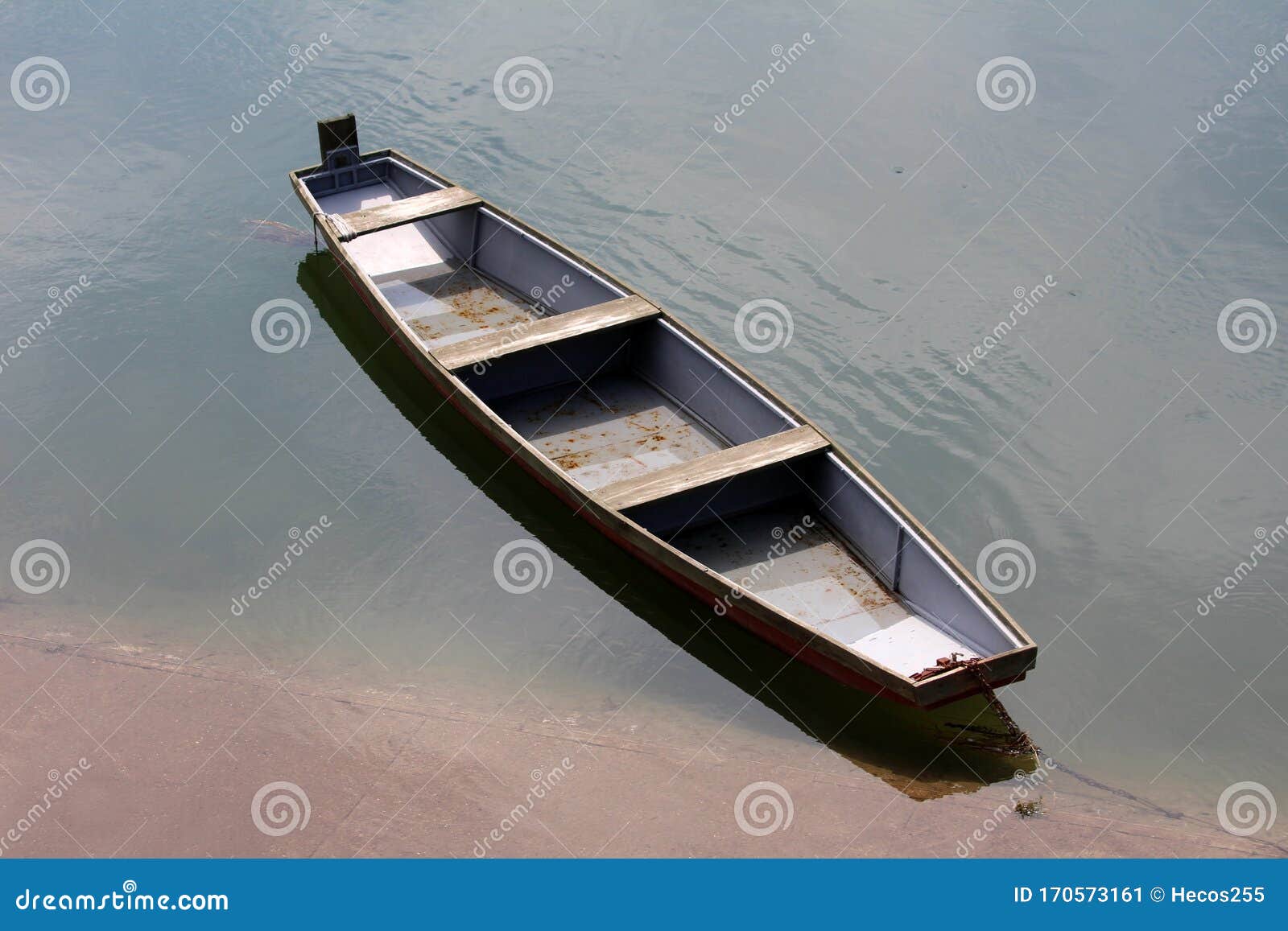 https://thumbs.dreamstime.com/z/wooden-river-boat-made-dilapidated-boards-grey-metal-parts-tied-to-concrete-bank-strong-rusted-chain-170573161.jpg