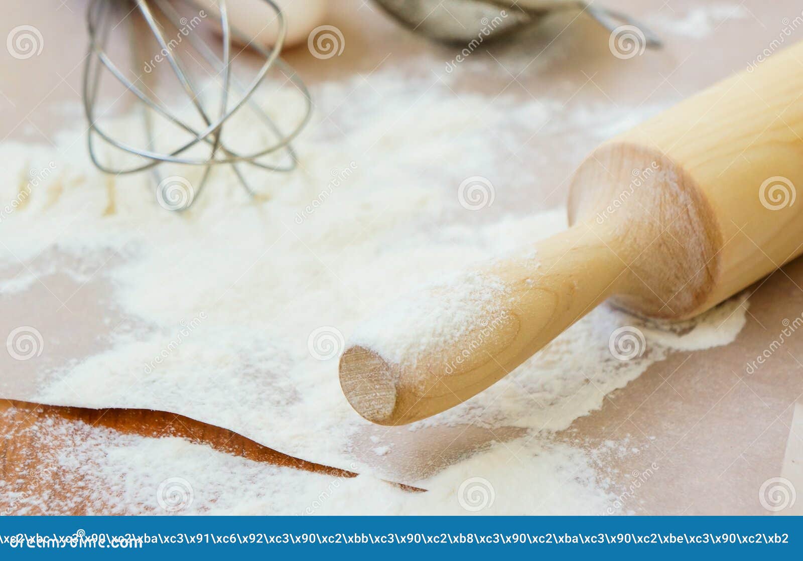 Wooden Rolling Pin Dusted with Flour on a Kitchen Table Stock Image
