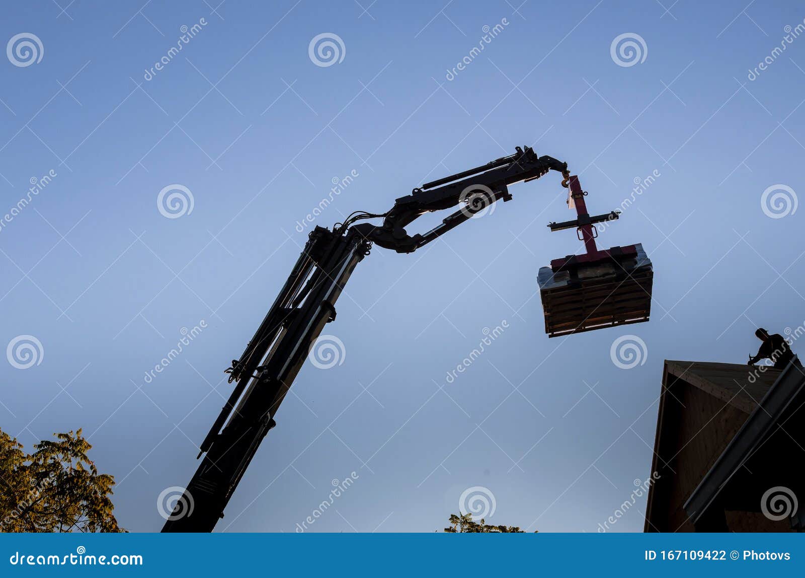 A Wooden Roof Truss Being Lifted By A Boom Truck Forklift In The Roof A New Home Stock Photo Image Of Work Platform 167109422