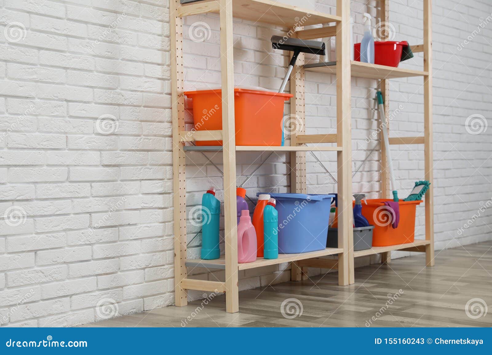 Wooden Shelving Units With Cleaning Equipment Near White