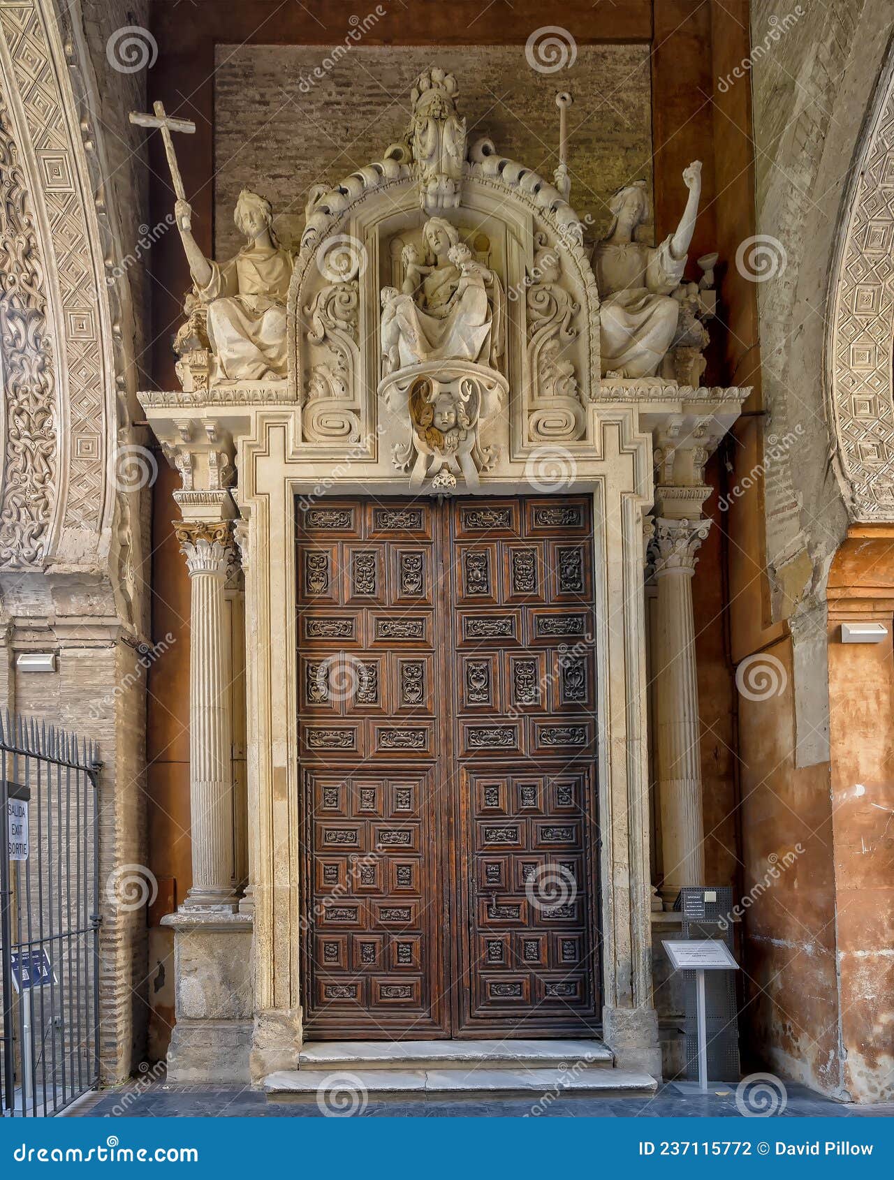 wooden side door in the puerta de perdon or door of forgiveness, the visitors entrance to the seville cathedral on alemanes street