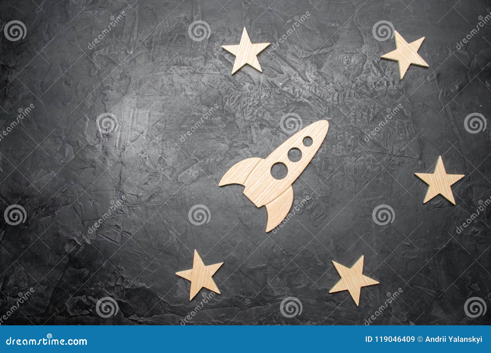 wooden space rocket and stars on a dark background. the concept of space travels, the study of planets and stars. education