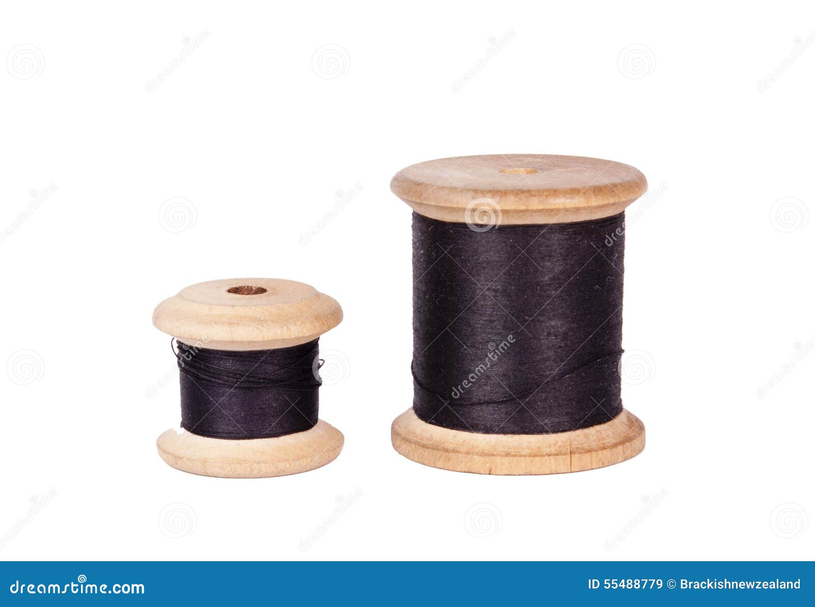 Wooden spools of thread isolated on white background.