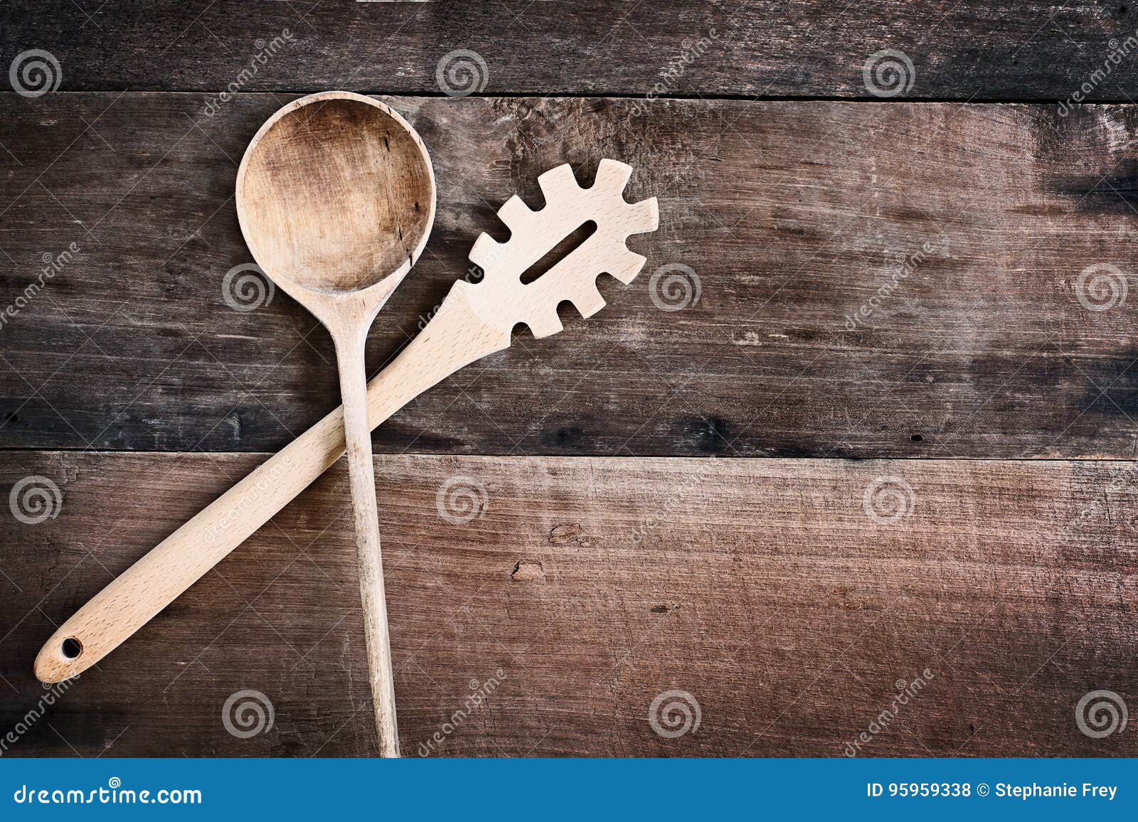 wooden spoon and spaghetti fork over wood background