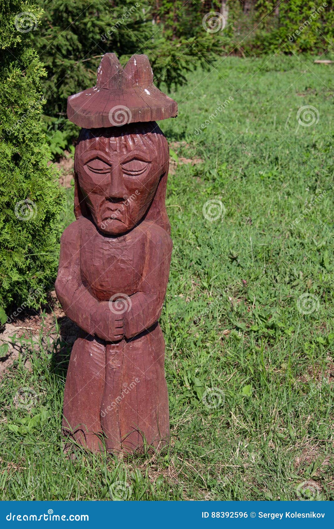 Wooden Statue in the Shape of a Woman in the Park Stock Photo Image