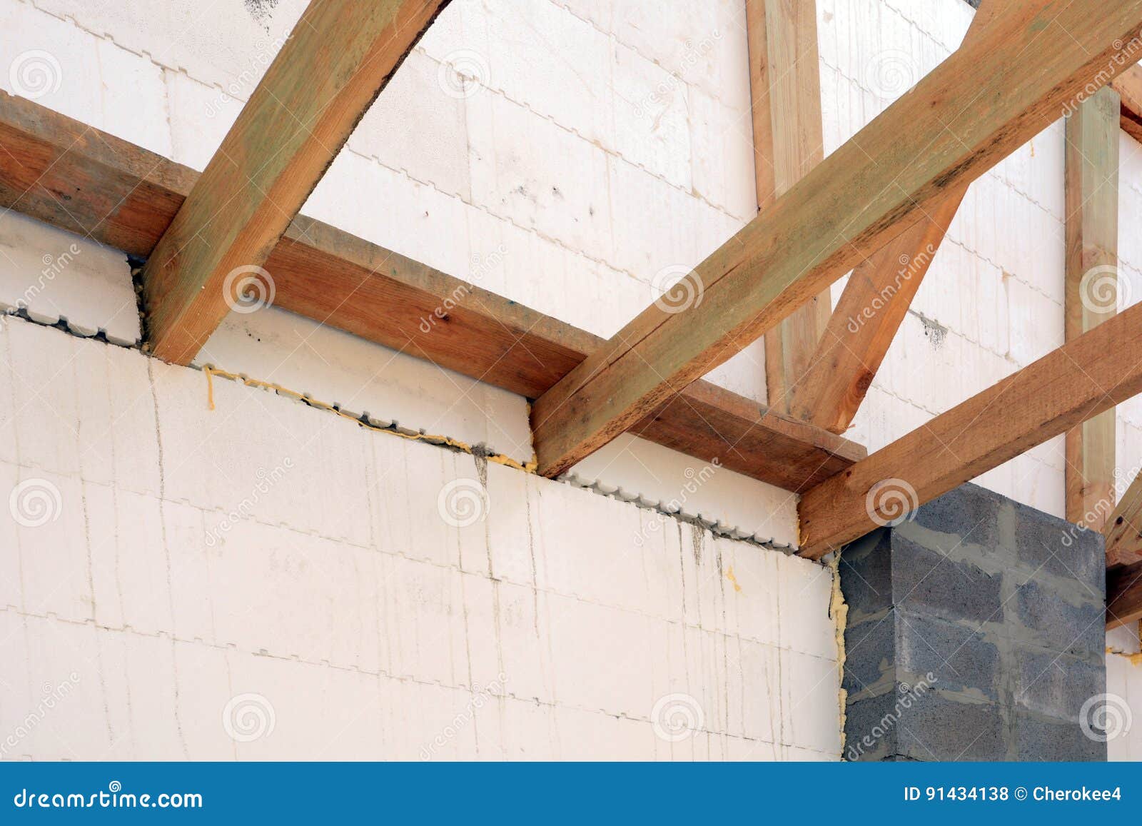 The wooden structure of the building. Installation of wooden beams at construction the roof truss system of the house. The wooden structure of the building. Wooden frame building. Wooden roof construction. house building. Installation of wooden beams at construction the roof truss system of the house.