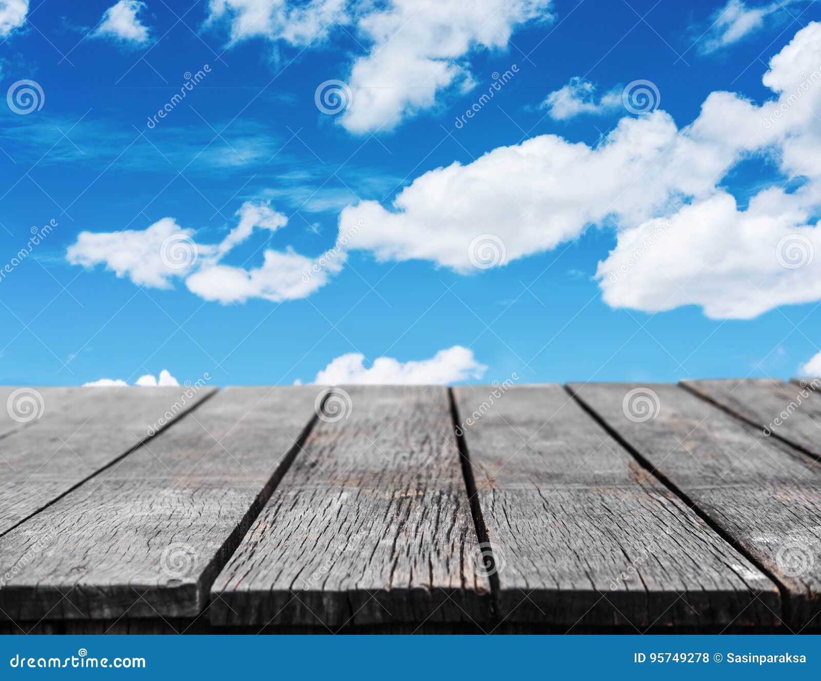 Wooden Table with Blue Sky and White Cloud Background Stock Photo