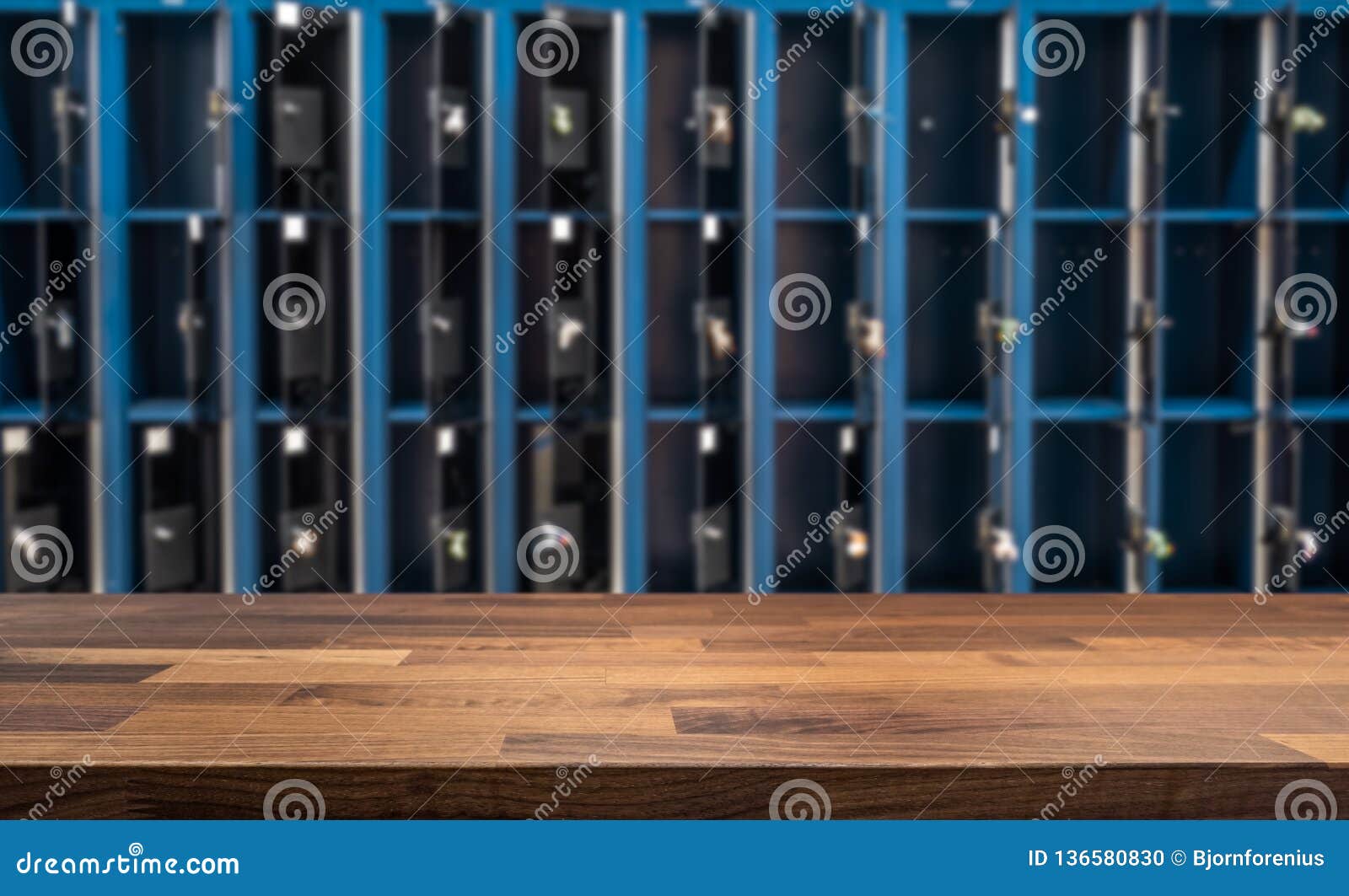 Wooden Table Top In Front Of Blurred Open Lockers In Locker