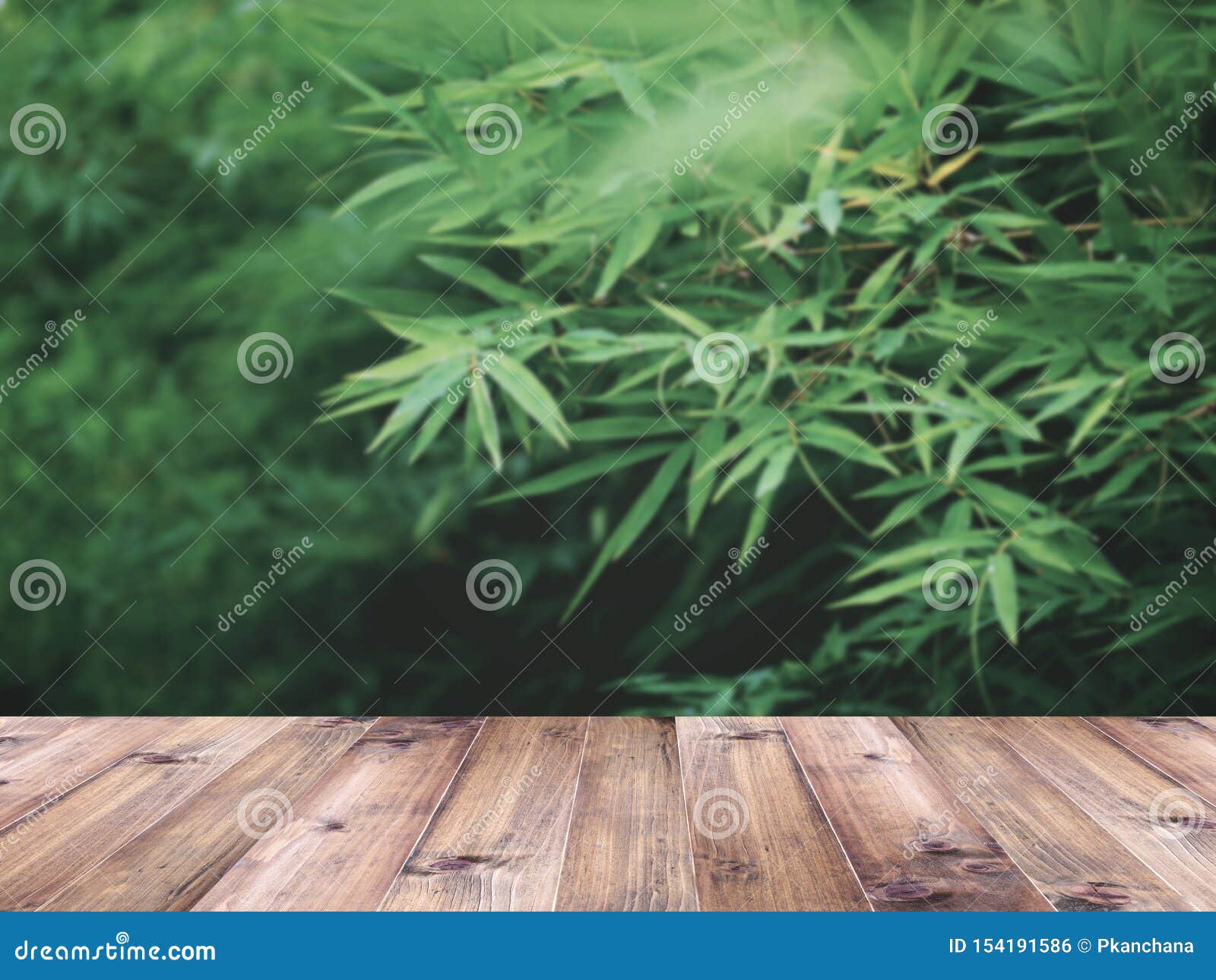 Wooden Table Top Over Green Grass In Summer Garden Stock Photo