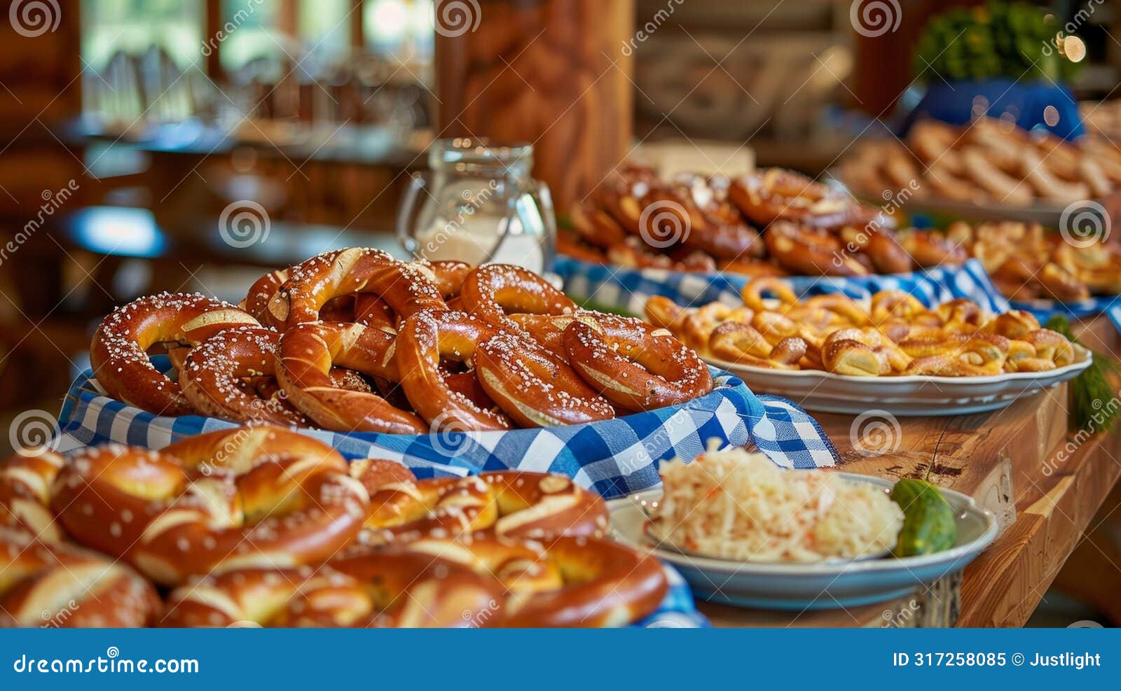 wooden tables decorated with blue and white checkered tablecloths adorned with overflowing platters of bratwurst