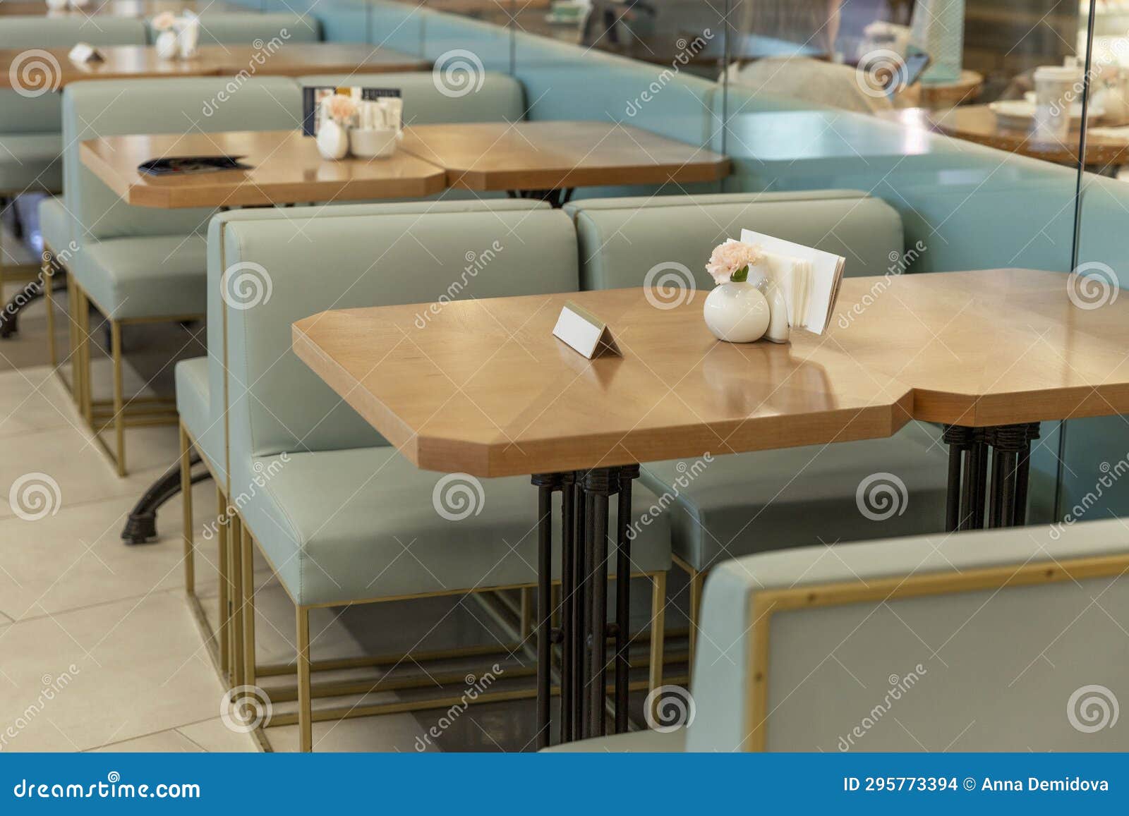 Wooden Tables with Turquoise Sofas in a Cozy Cafe Stock Photo Image